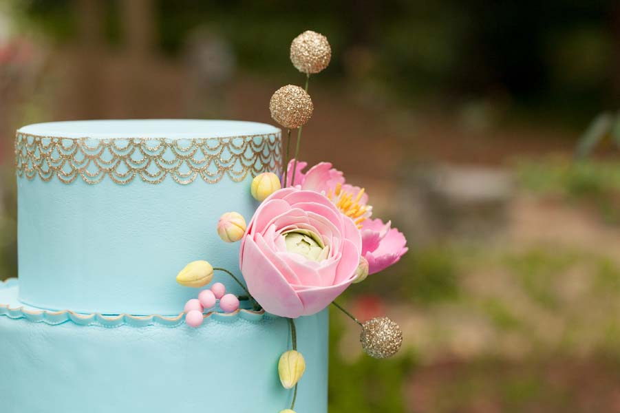 sugar flowers on blue and gold cake