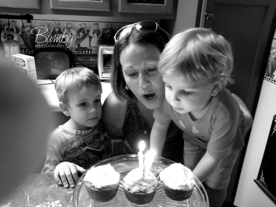 boys helping blow out mommas birthday candles