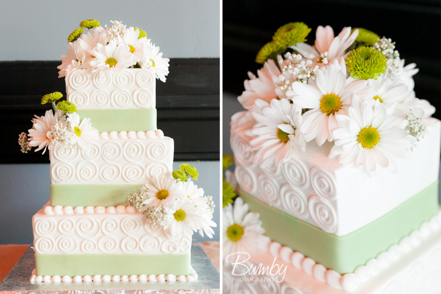 white and green topped with daisies wedding cake