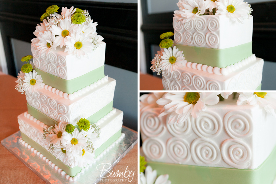 white and green topped with daisies wedding cake