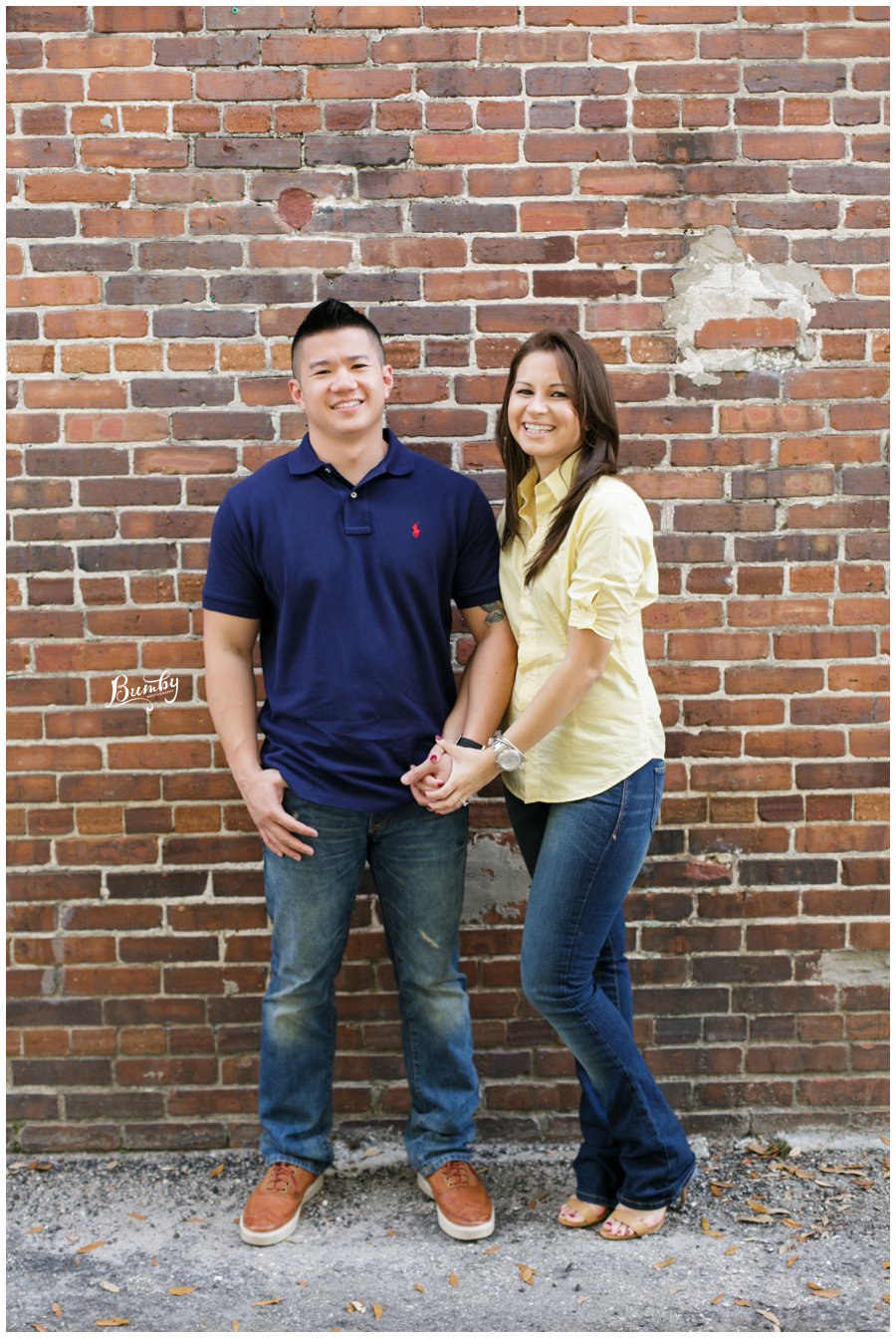 sanford engagement session couple against brick wall