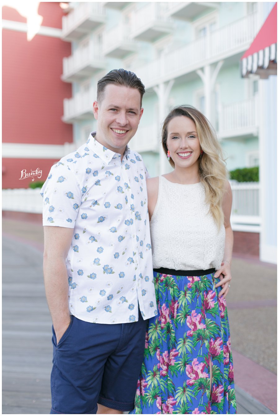 Engaged couple posing for their Disney boardwalk engagement session.