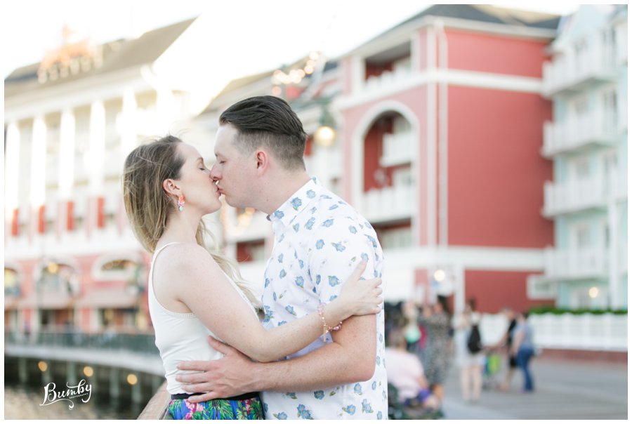 Couple kissing on the Disney boardwalk.