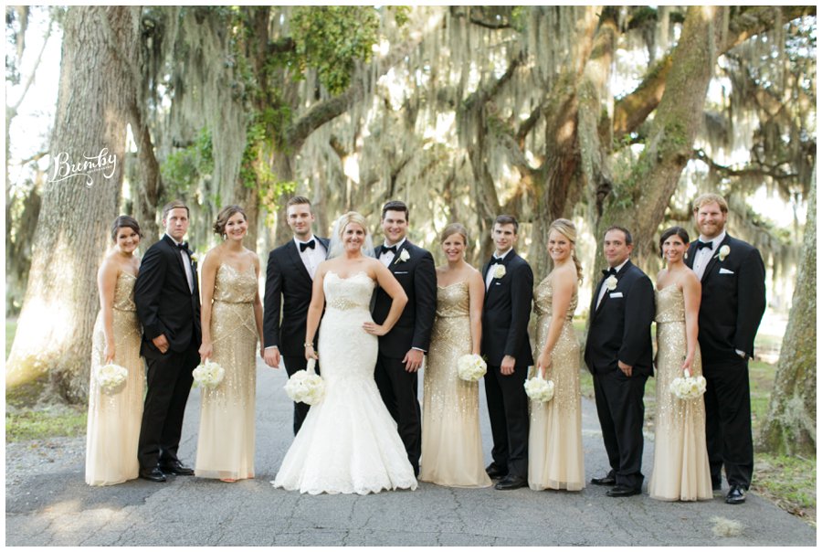 Entire southern wedding standing under old oak trees for a photo.