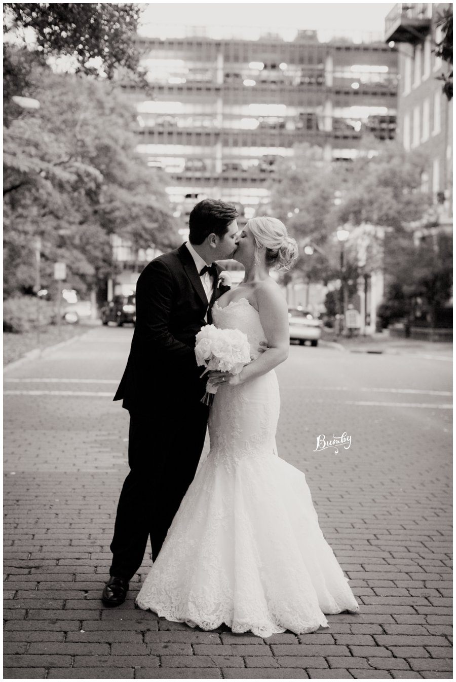 Bride and groom kissing in the middle of the streets of Savannah, Georgia.