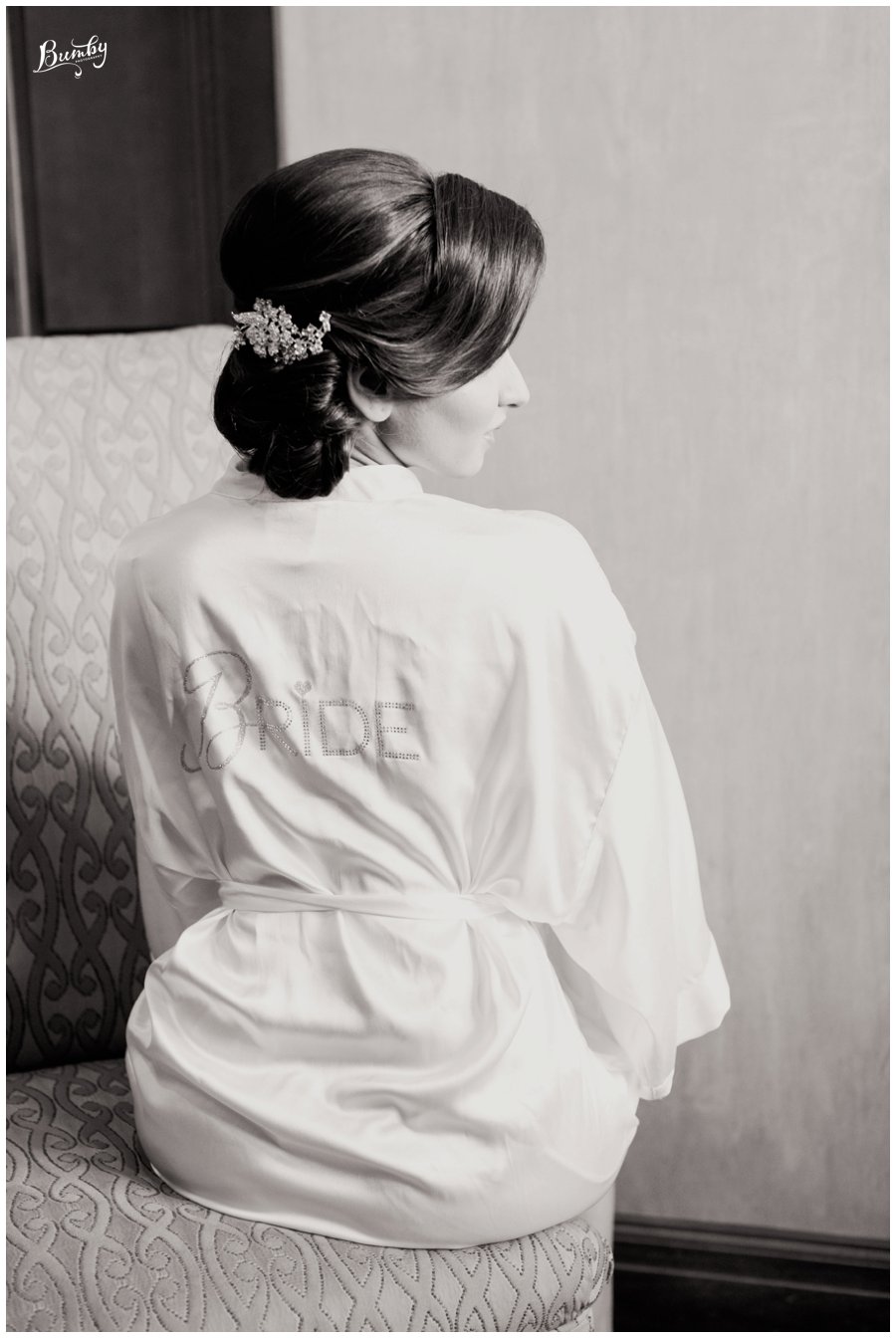 Black and white photo of the bride's updo hairstyle. 