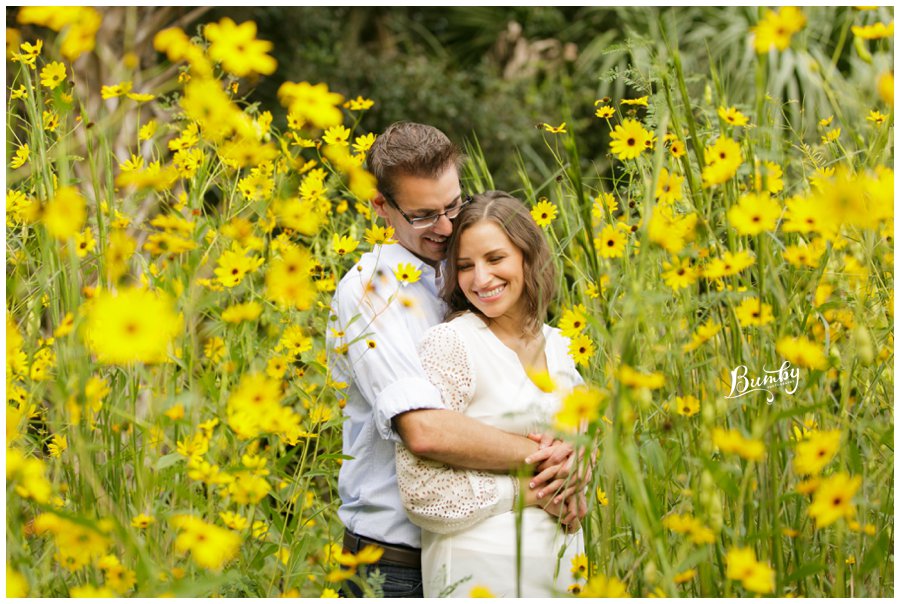 Couple hugging in a field of sunflowers.