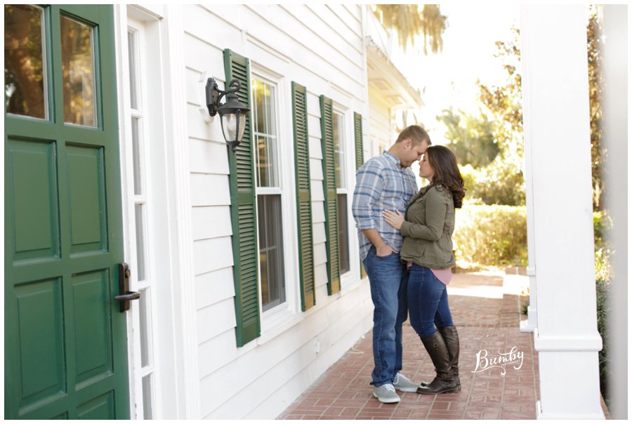 Couple standing on the front porch during engagement session.
