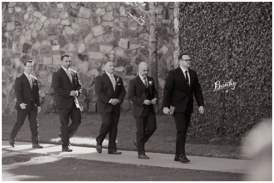 Groom and groomsmen walking to the ceremony site. 
