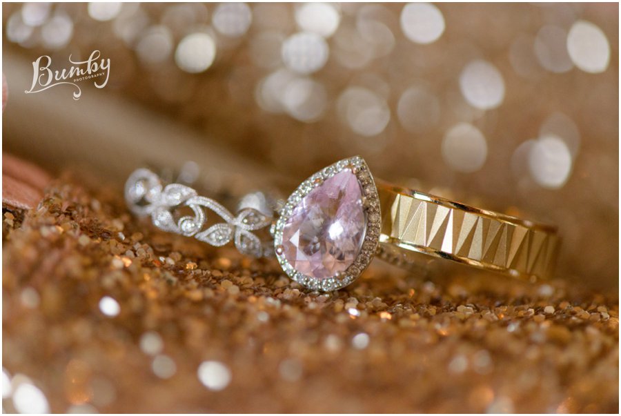 Photo of wedding bands and pink diamond engagement ring.
