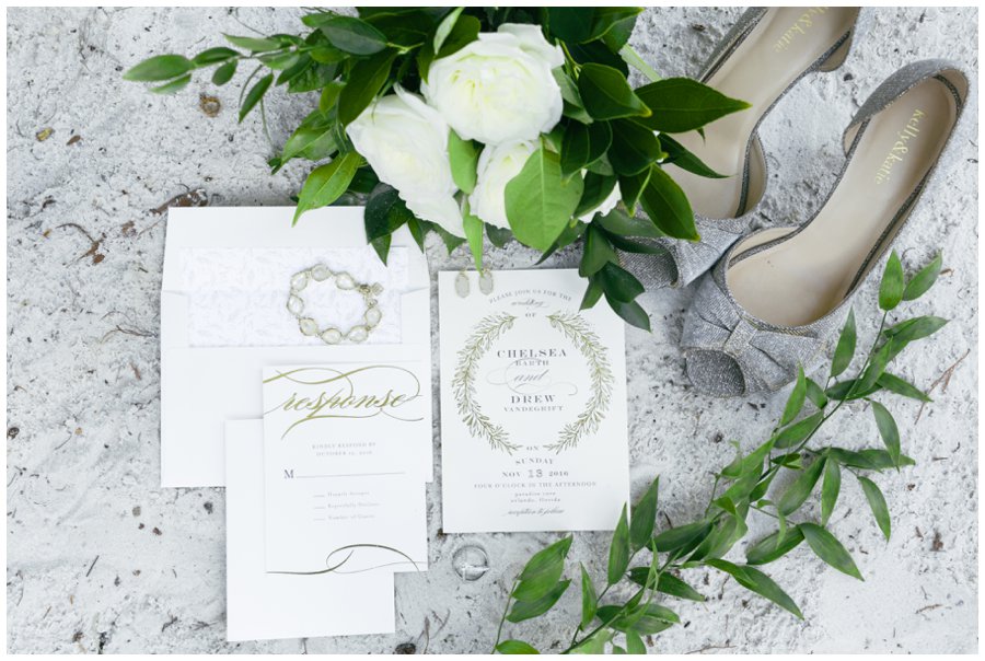 wedding invitation and shoes in sand paradise cove wedding