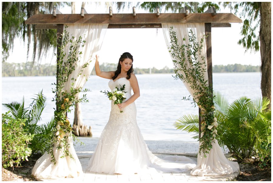 bridal portrait under wedding arch at paradise cove