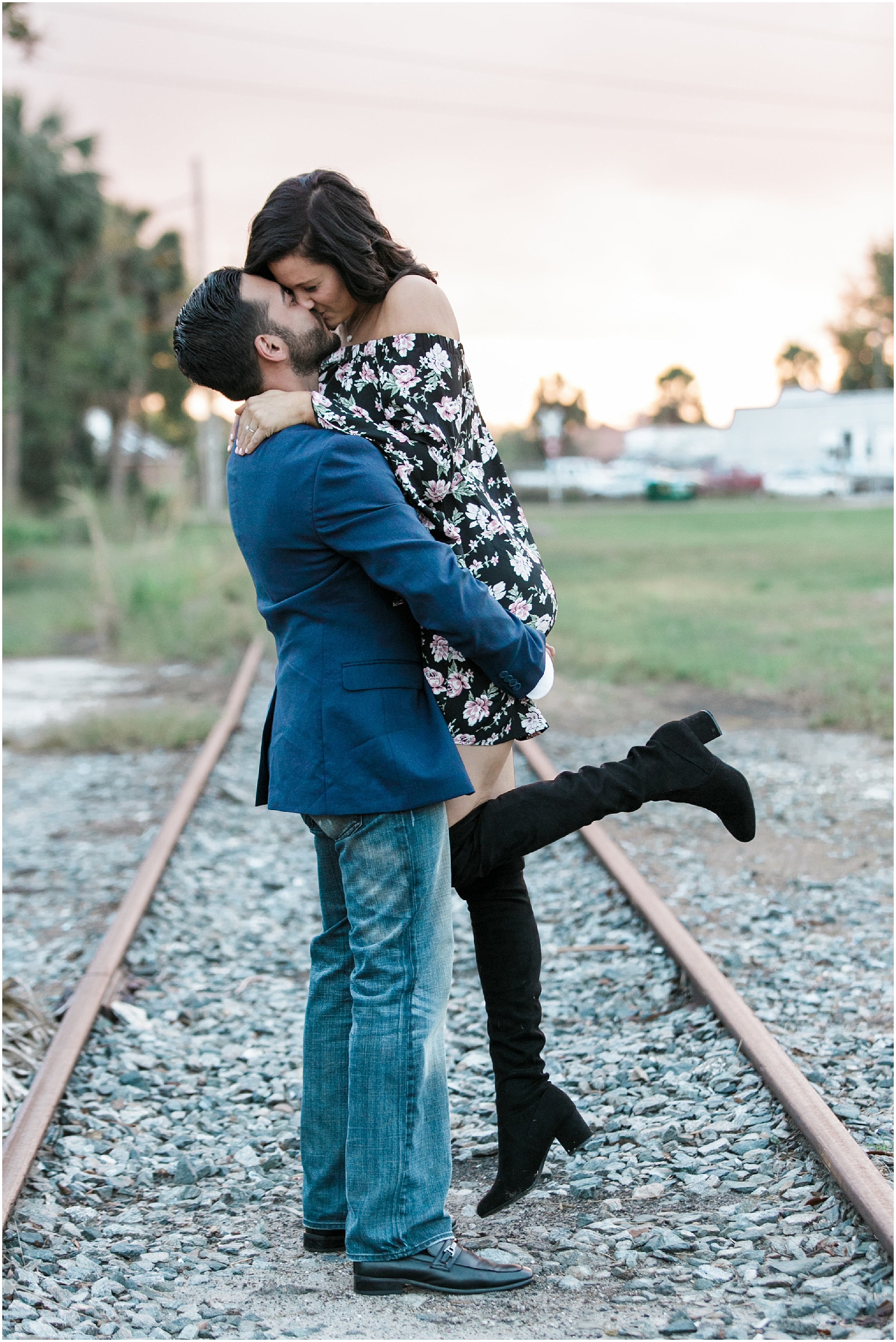 sweet historic engagement session couple kissing on train tracks