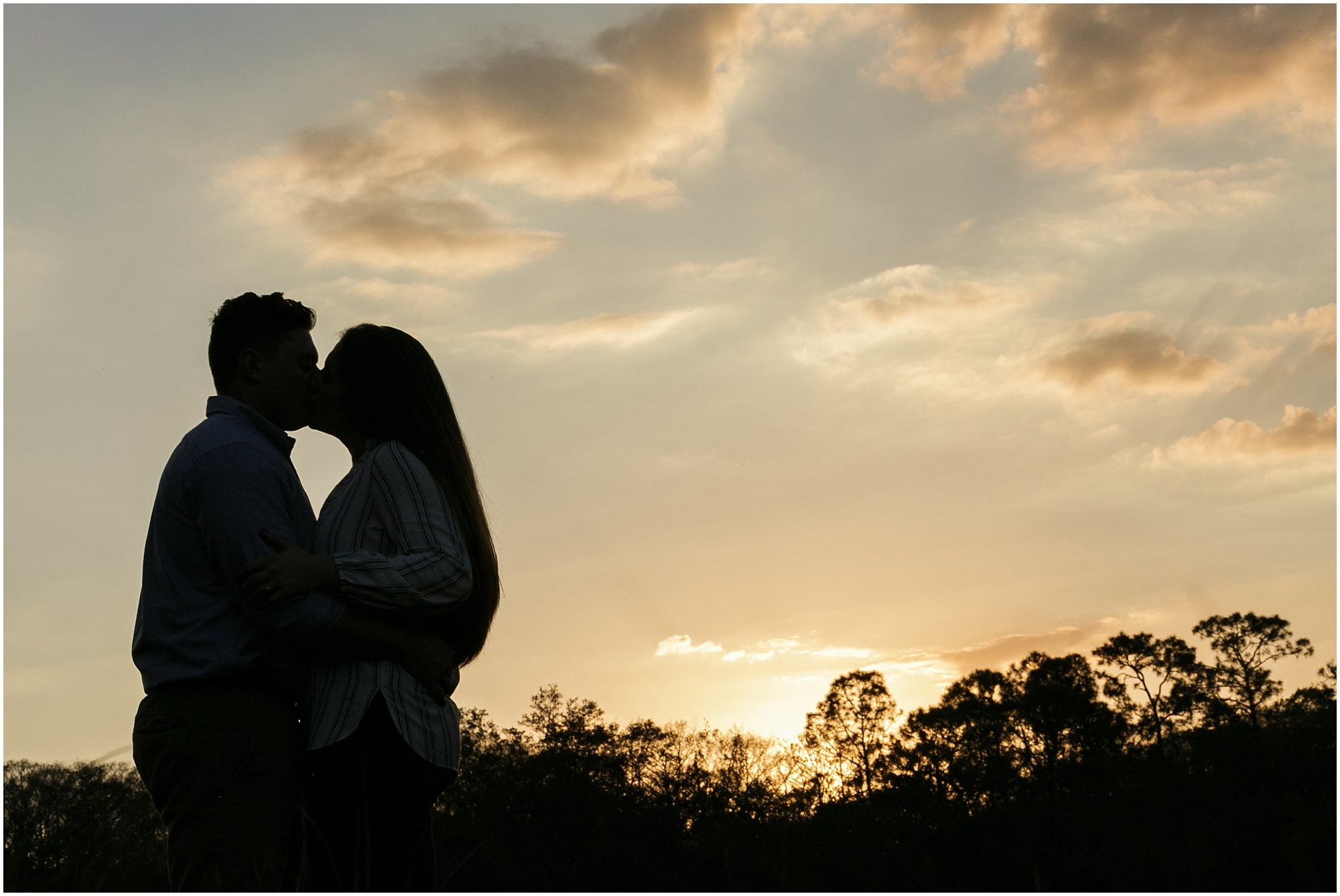 Couple kissing during sunset at Kempfer Ranch