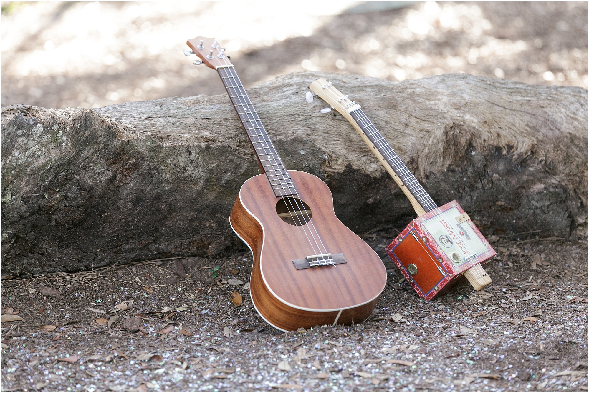 Musical Outdoor Engagement Session guitar and handmade ukulele laying on the ground