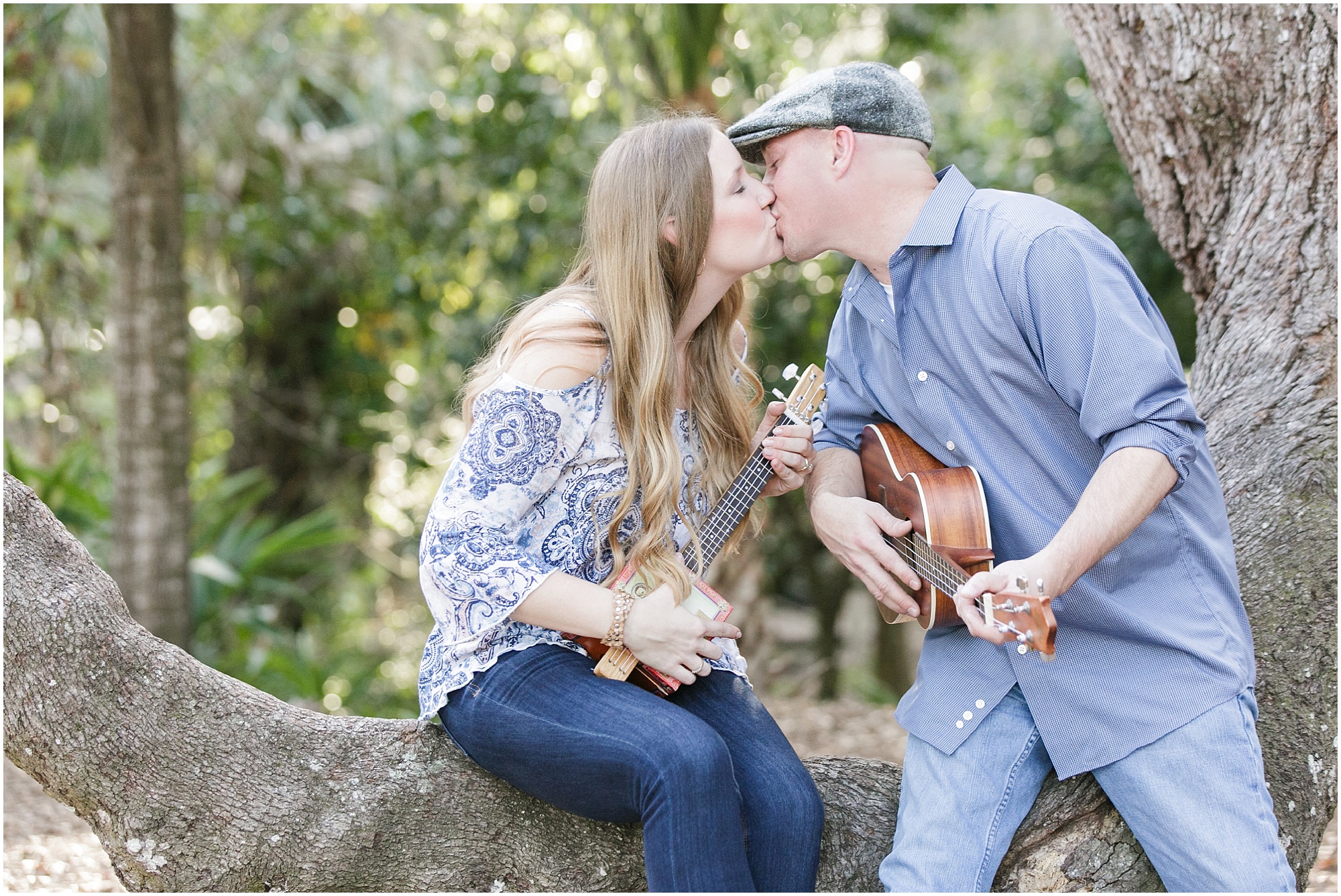 Musical outdoor engagement session couple kissing in a tree.