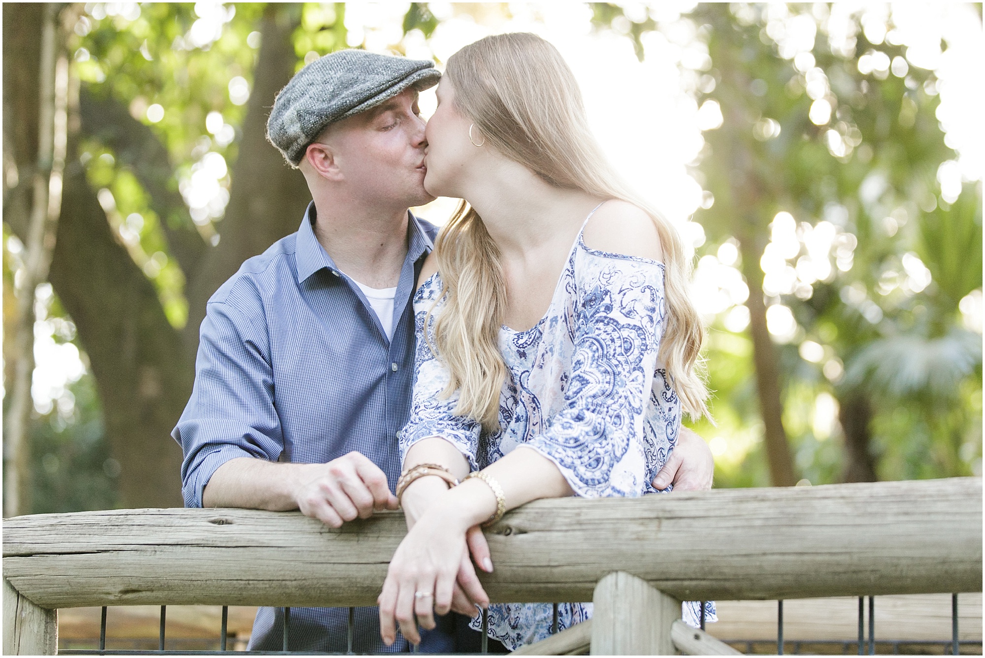 Couple kissing on wooden bridge near downtown Orlando.
