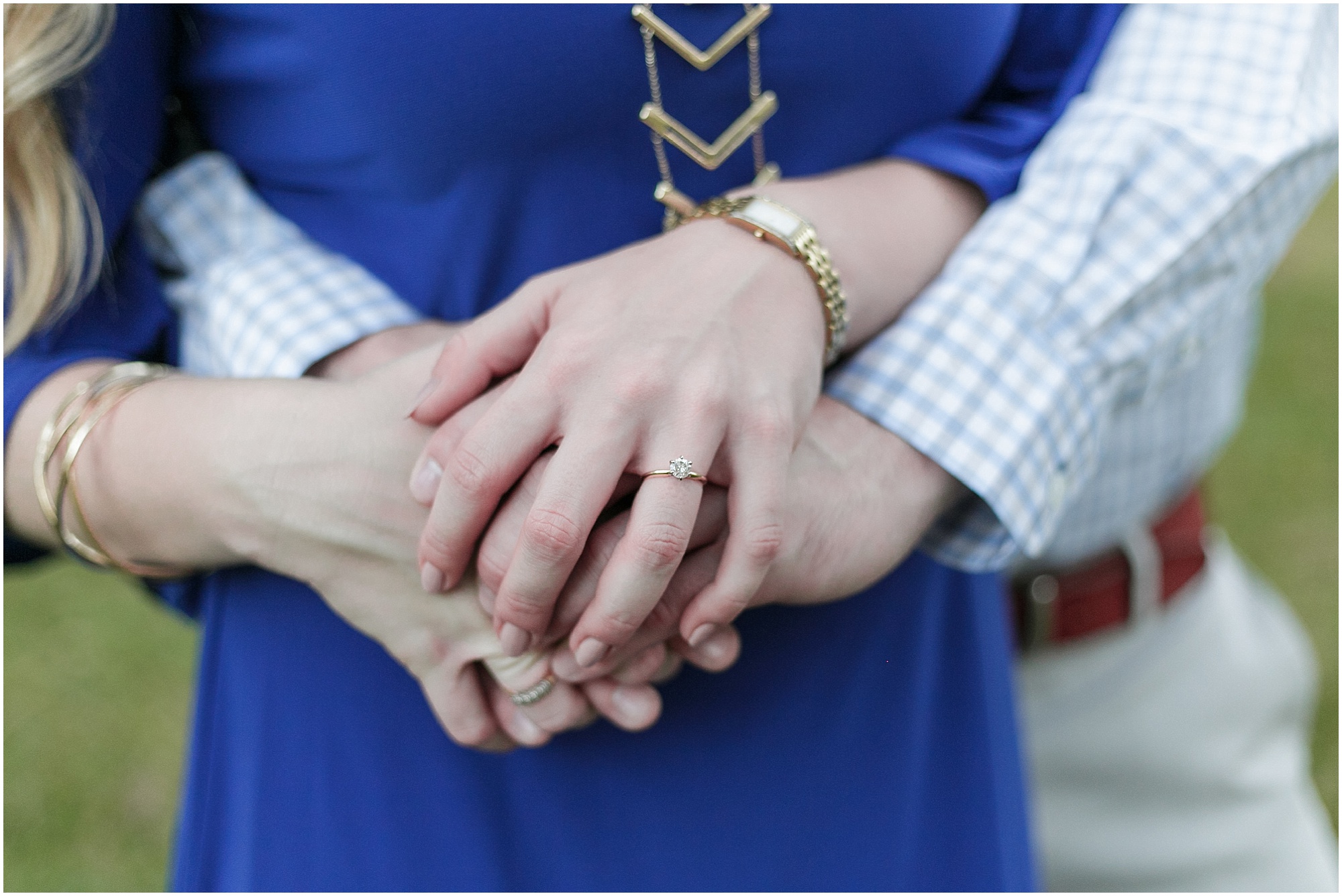 Guy holding woman hands while showing engagement ring.