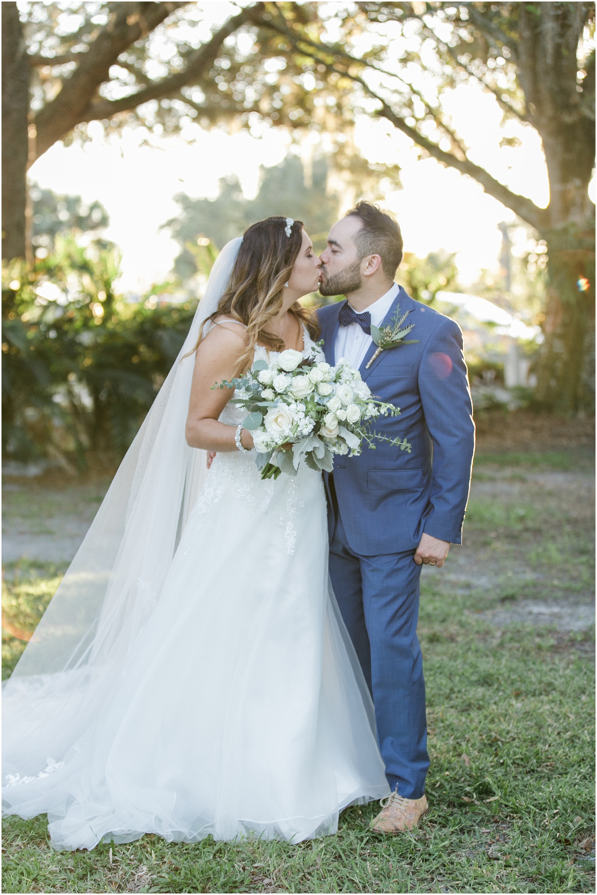 Portrait of bride and groom kissing