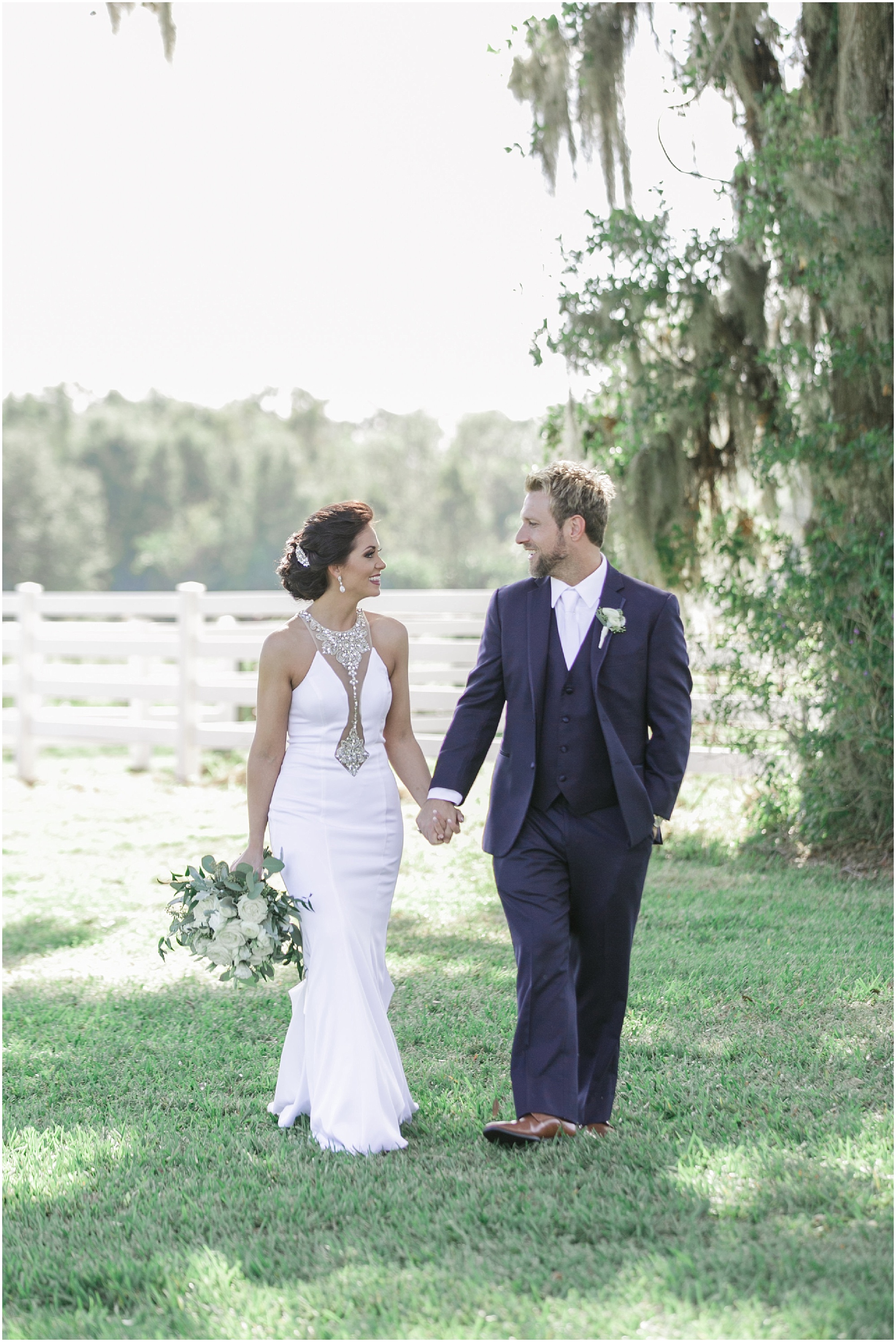 Southern Elegance bride and groom walking and holding hands.