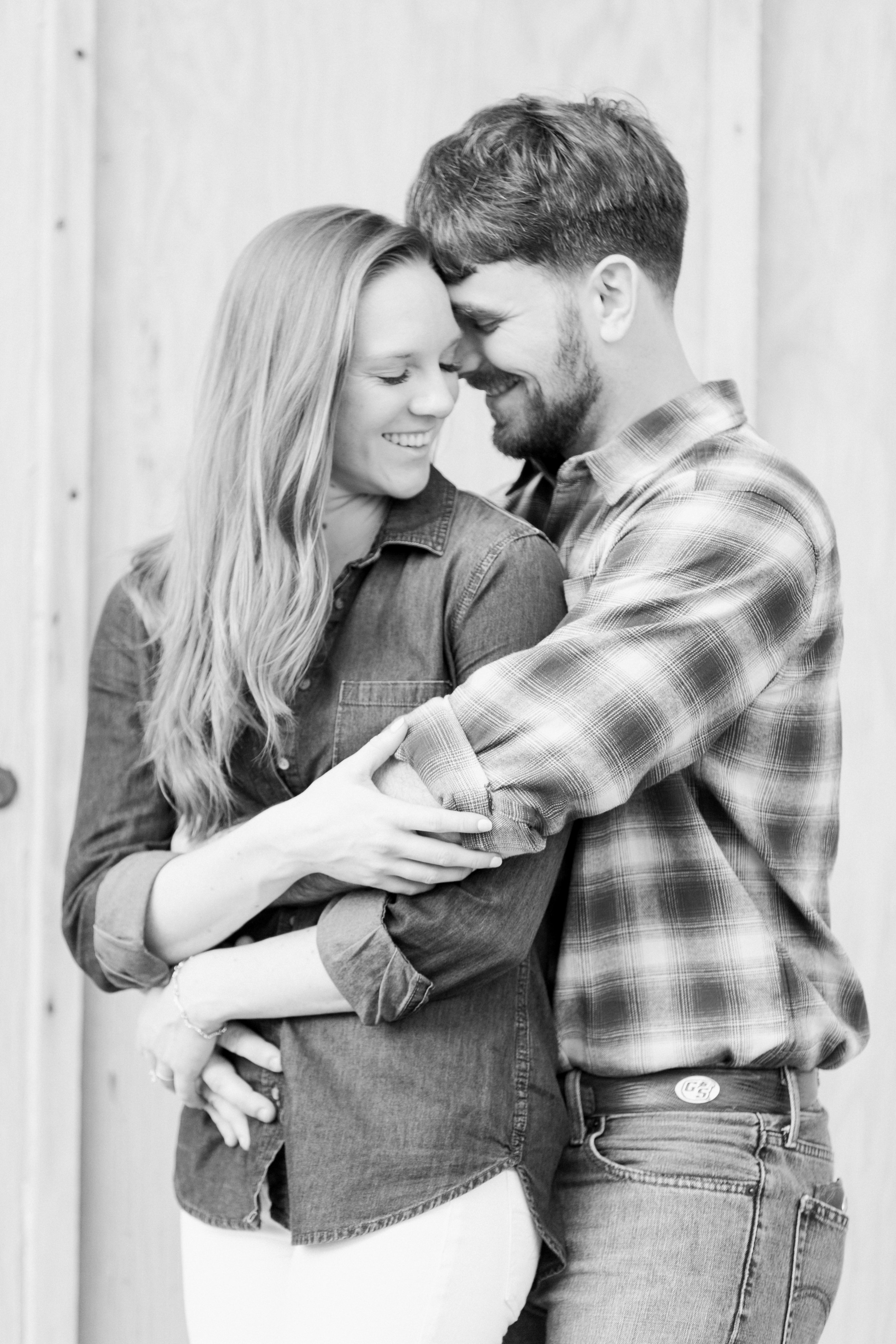 Guy hugging girl from behind at engagement session