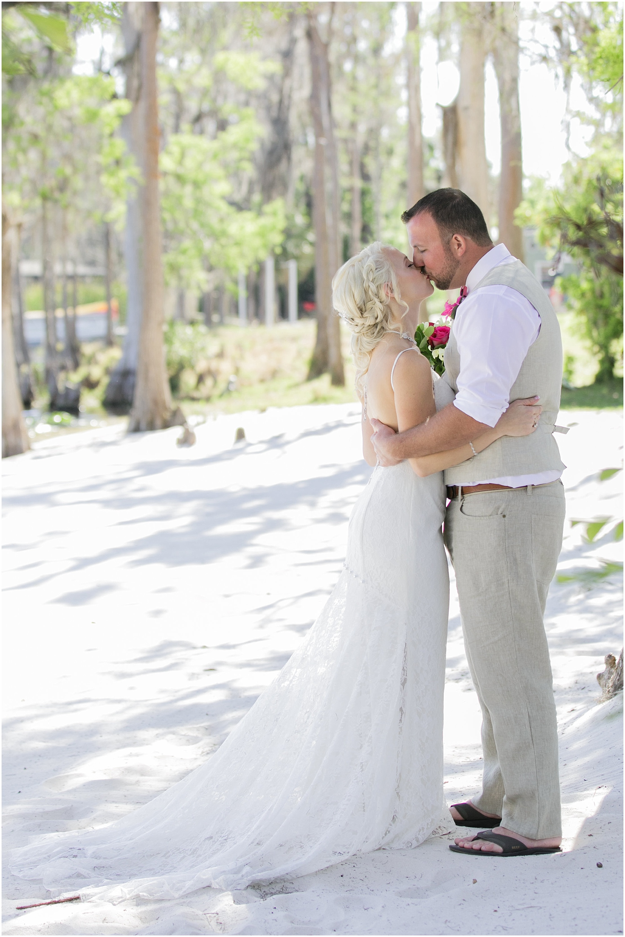 Bride and groom sharing a kiss on the shoreline of Paradise Cove.