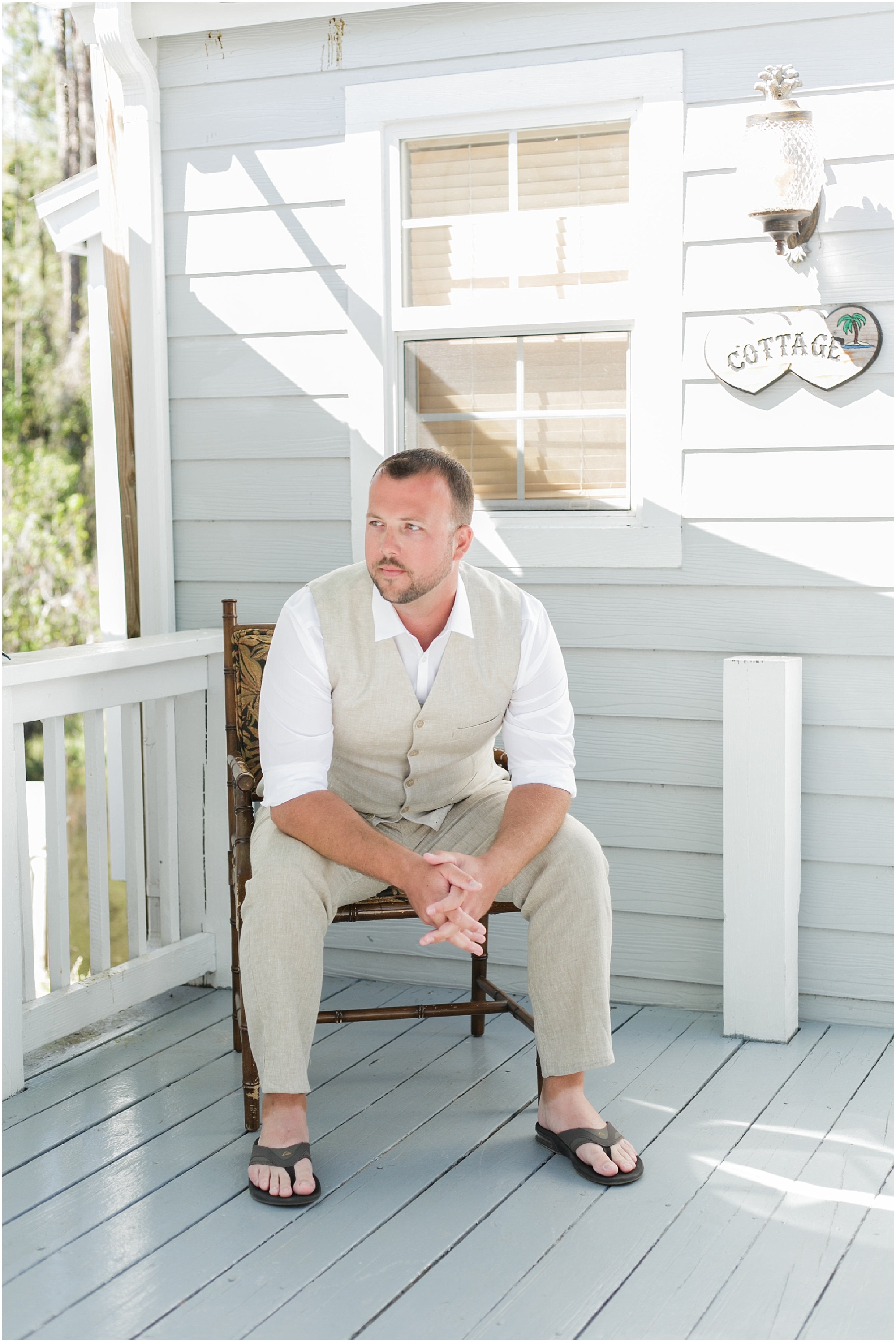 Groom sitting outside on the porch before he gets ready for Paradise Cove wedding.
