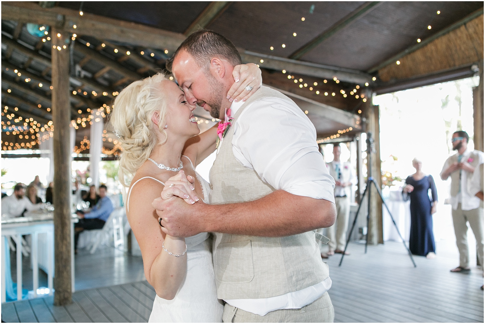 Groom and bride dance close to each other under the pavilion at Paradise Cove. 