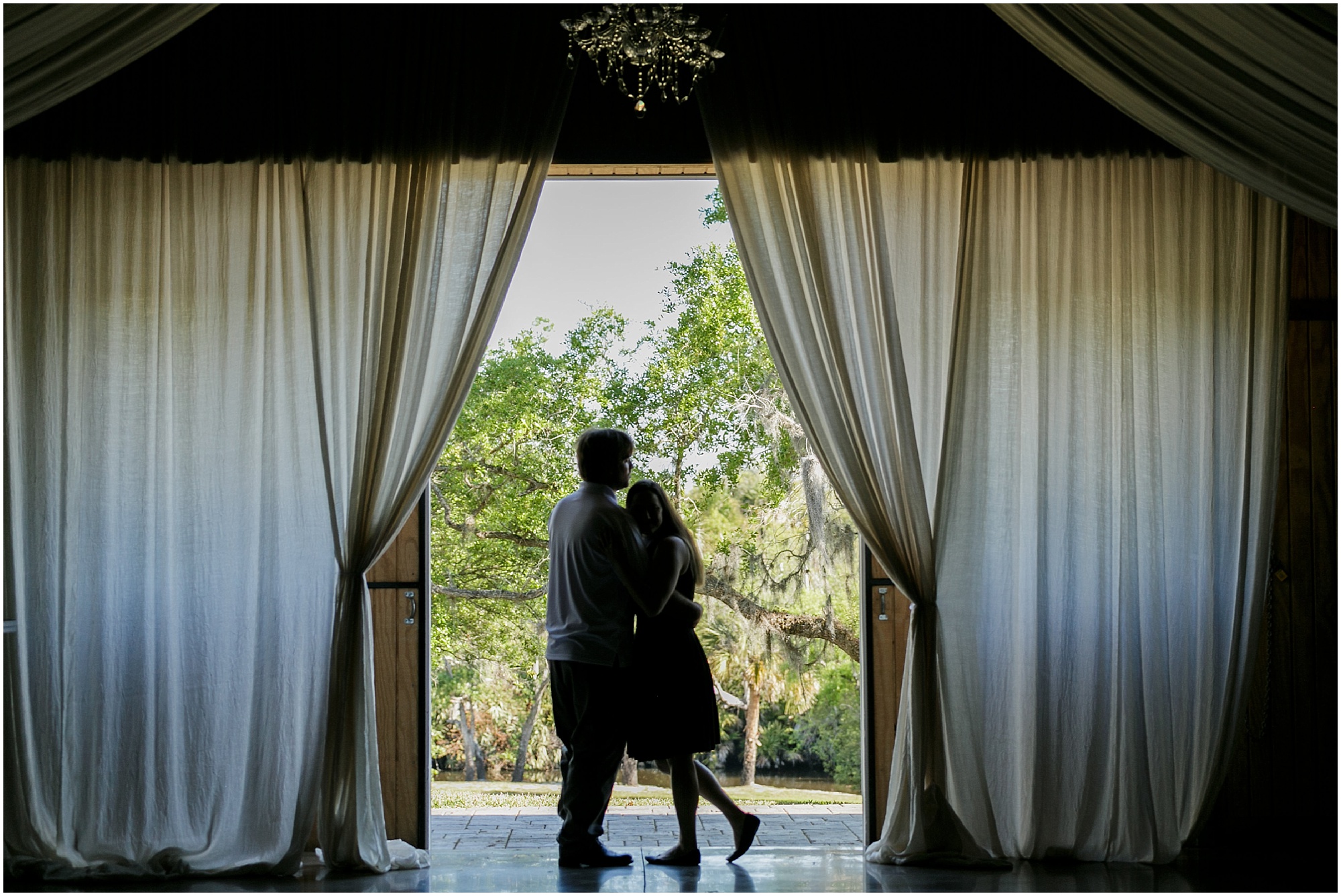 Silhouette of a couple in the door frame of the Up the Creek Farms venue. 