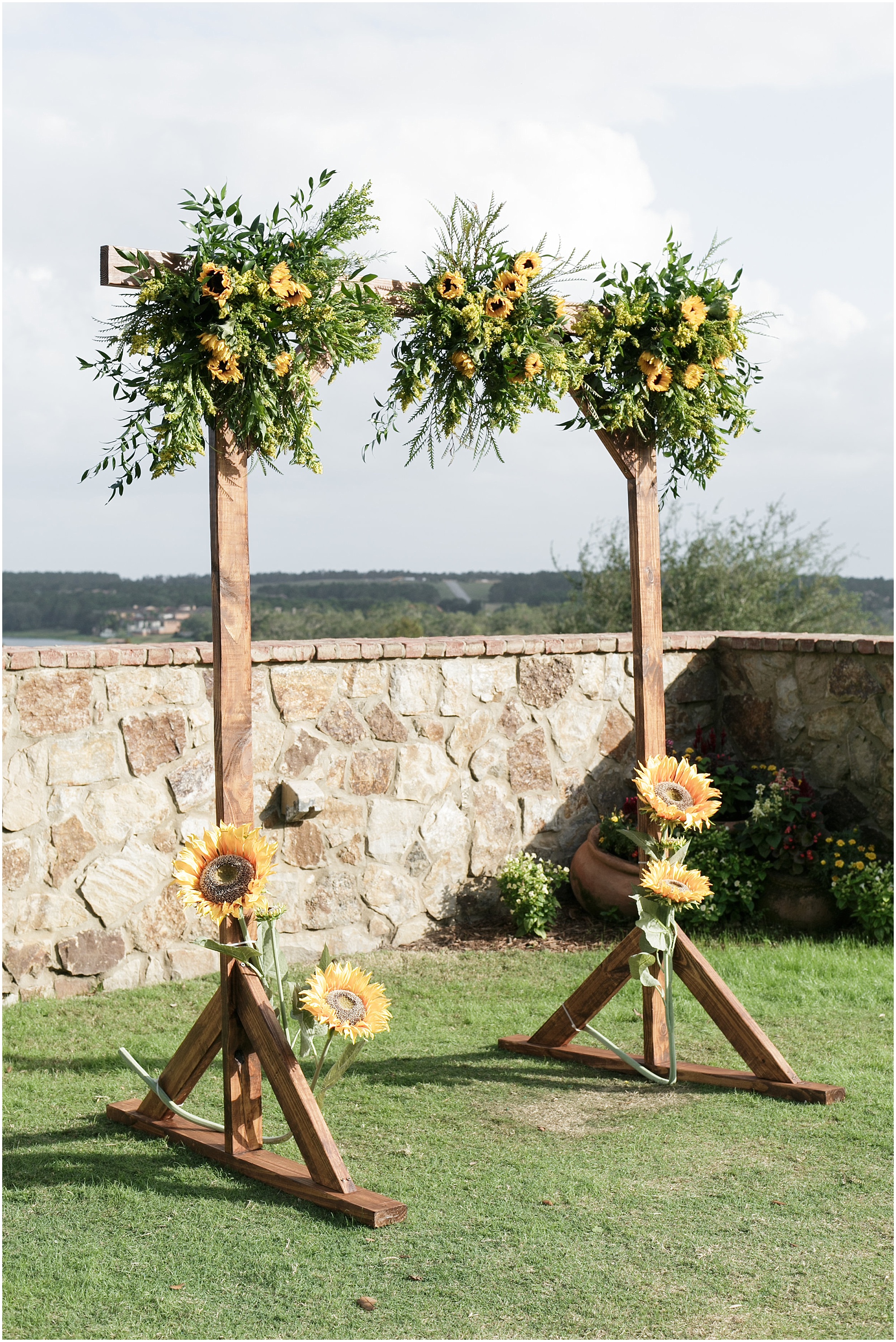 Sunflowers hanging over the wedding arch. 