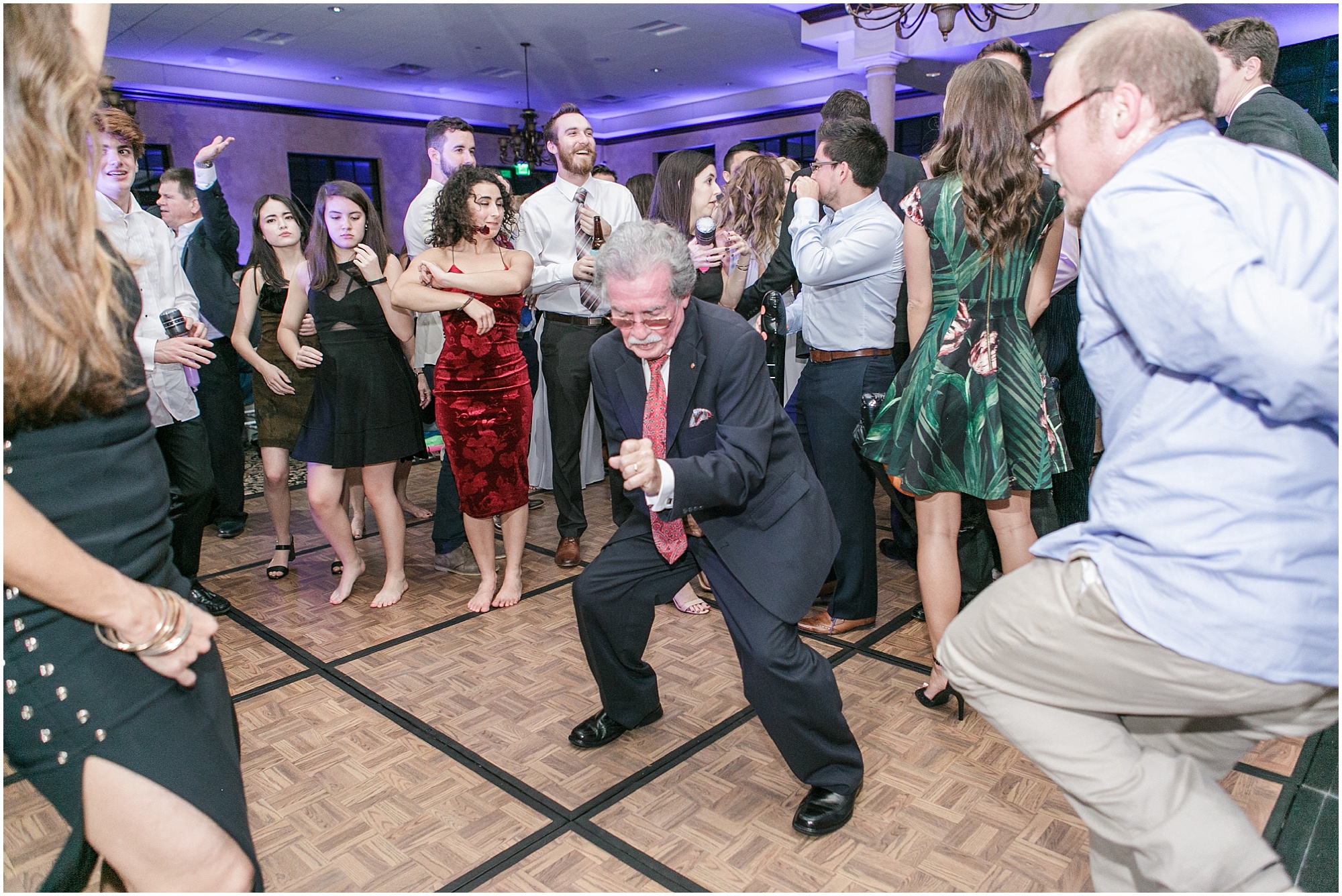 Guests at autumn sunflower wedding reception dancing and having fun. 
