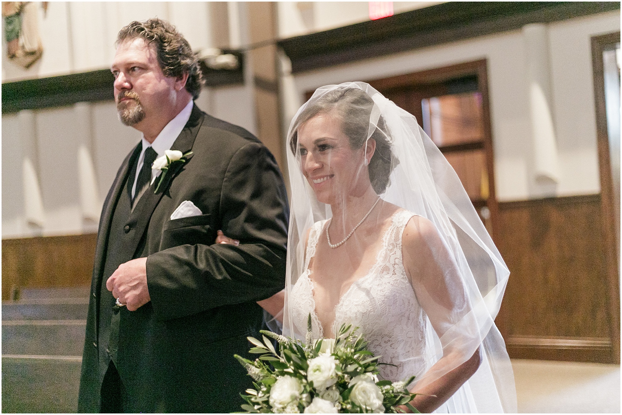Bride walks with her father at her wedding.