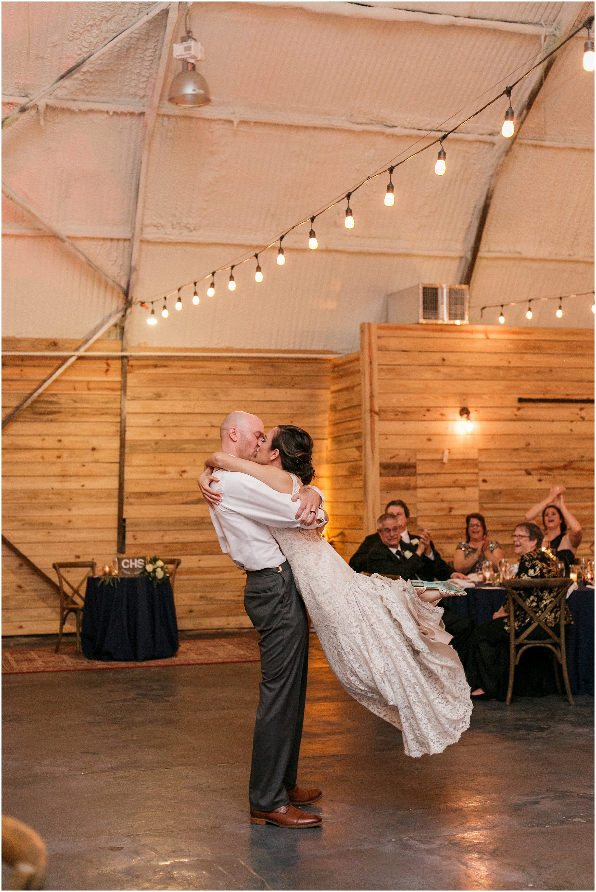 Bride and groom kiss at the end of their first dance.
