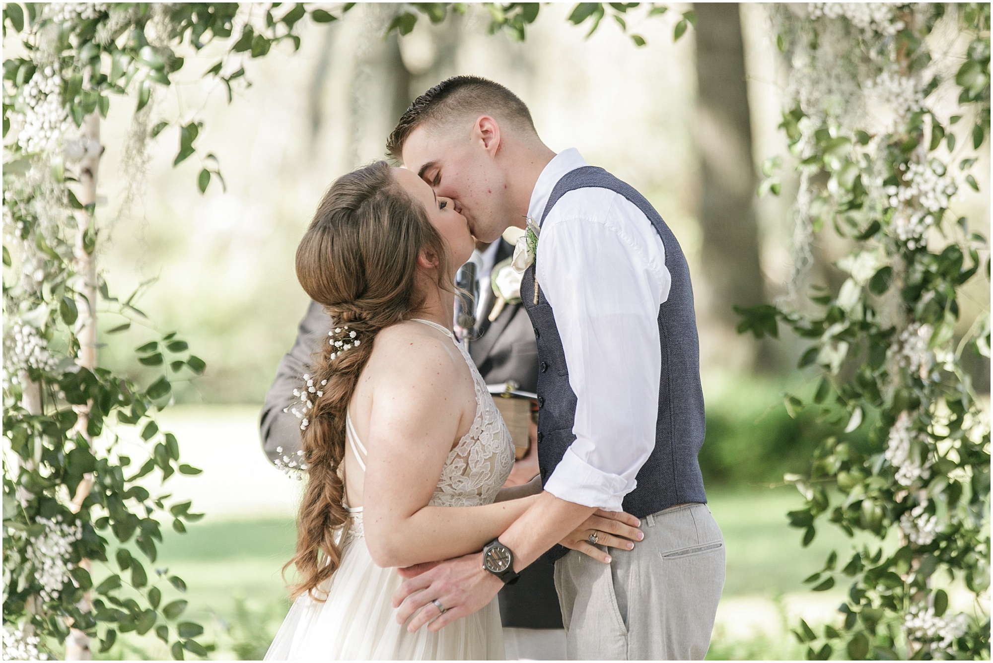 Bride and groom having their first kiss after being married