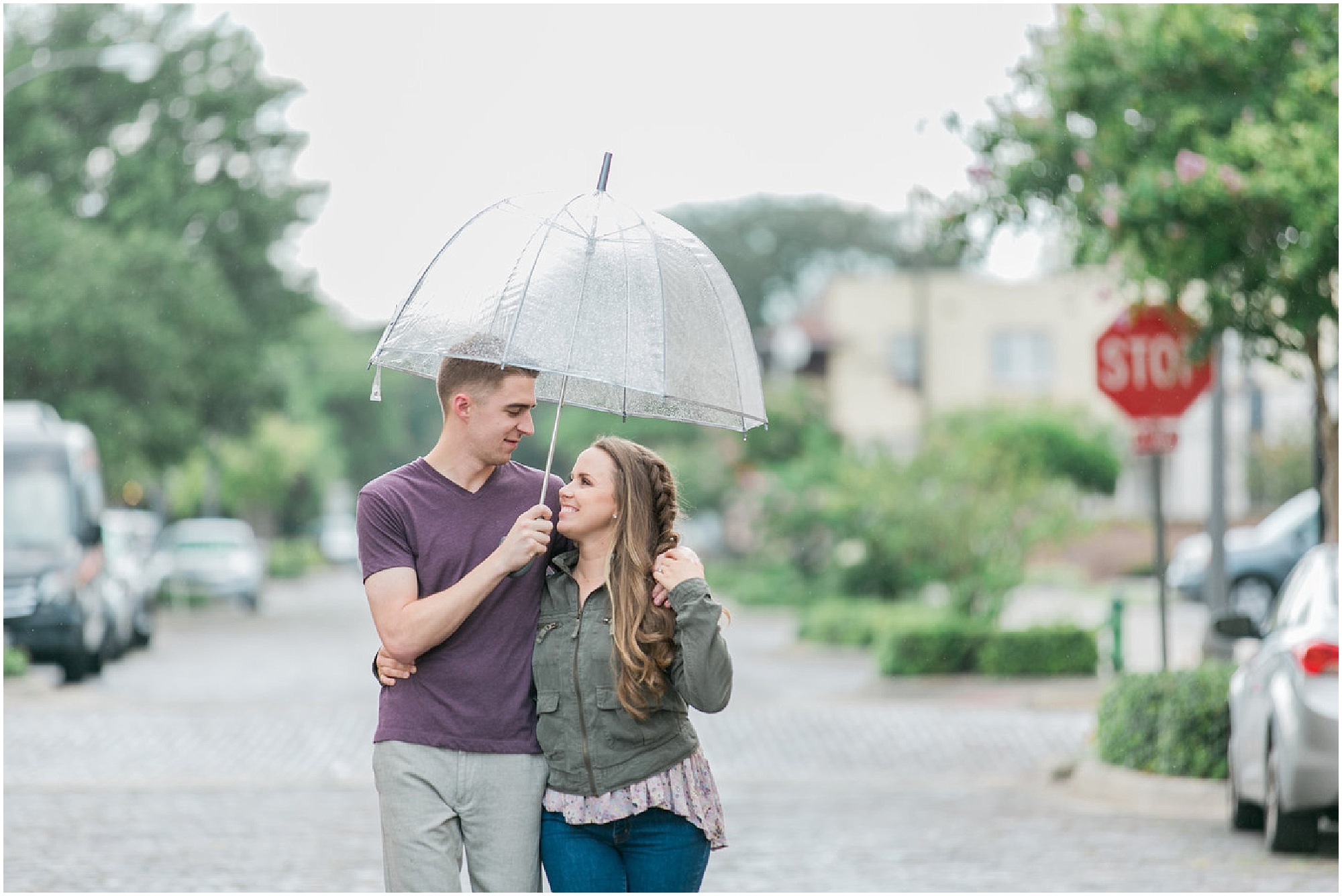 Guy holding an umbrella at engagement session.