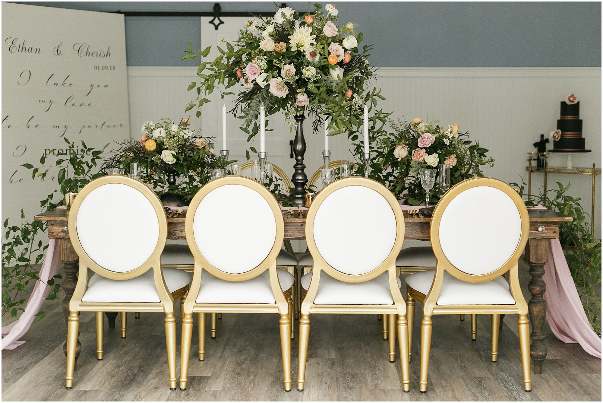 Indoor reception setup with greenery and brass highlights.