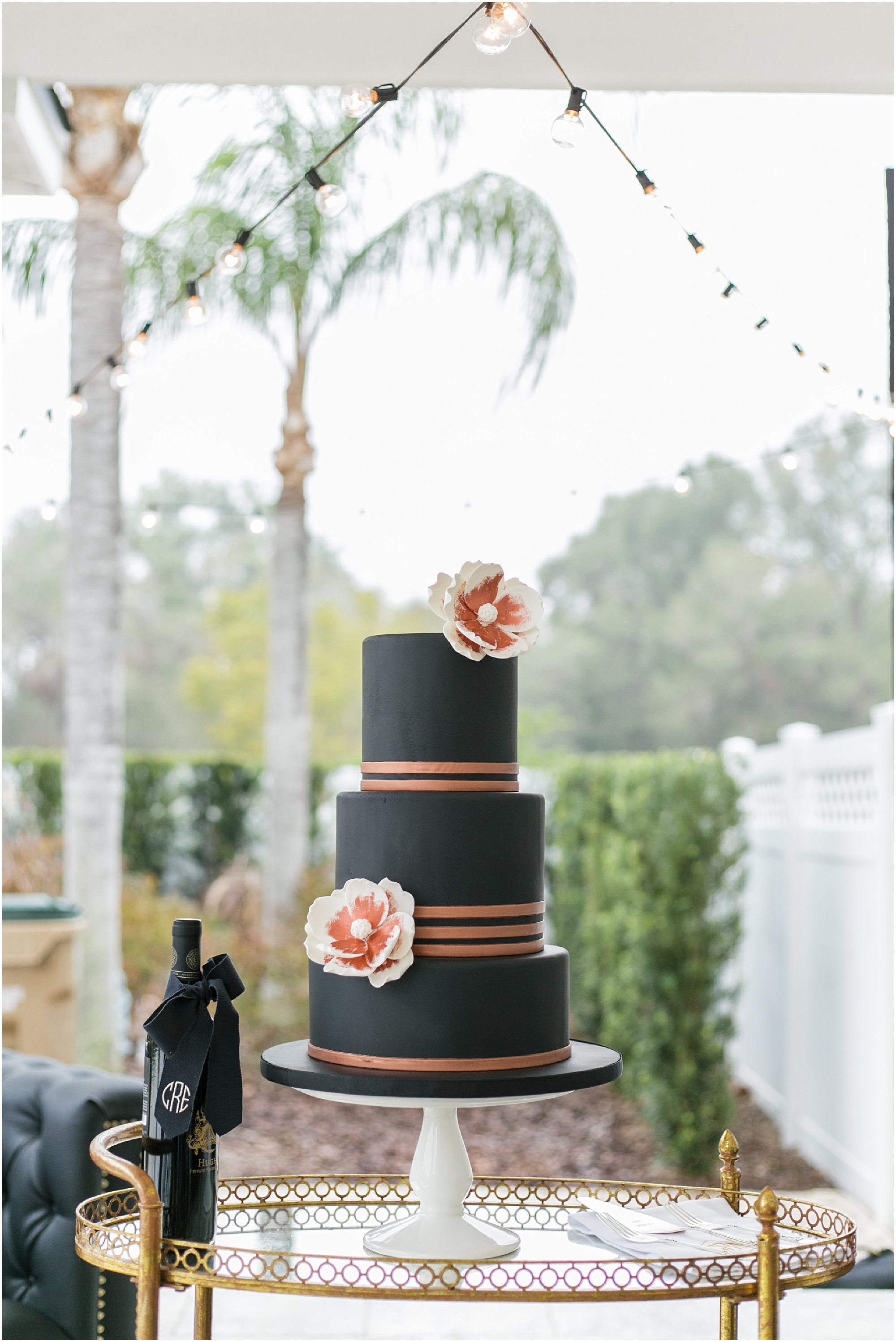 Black, pink and ivory wedding cake on the terrace.