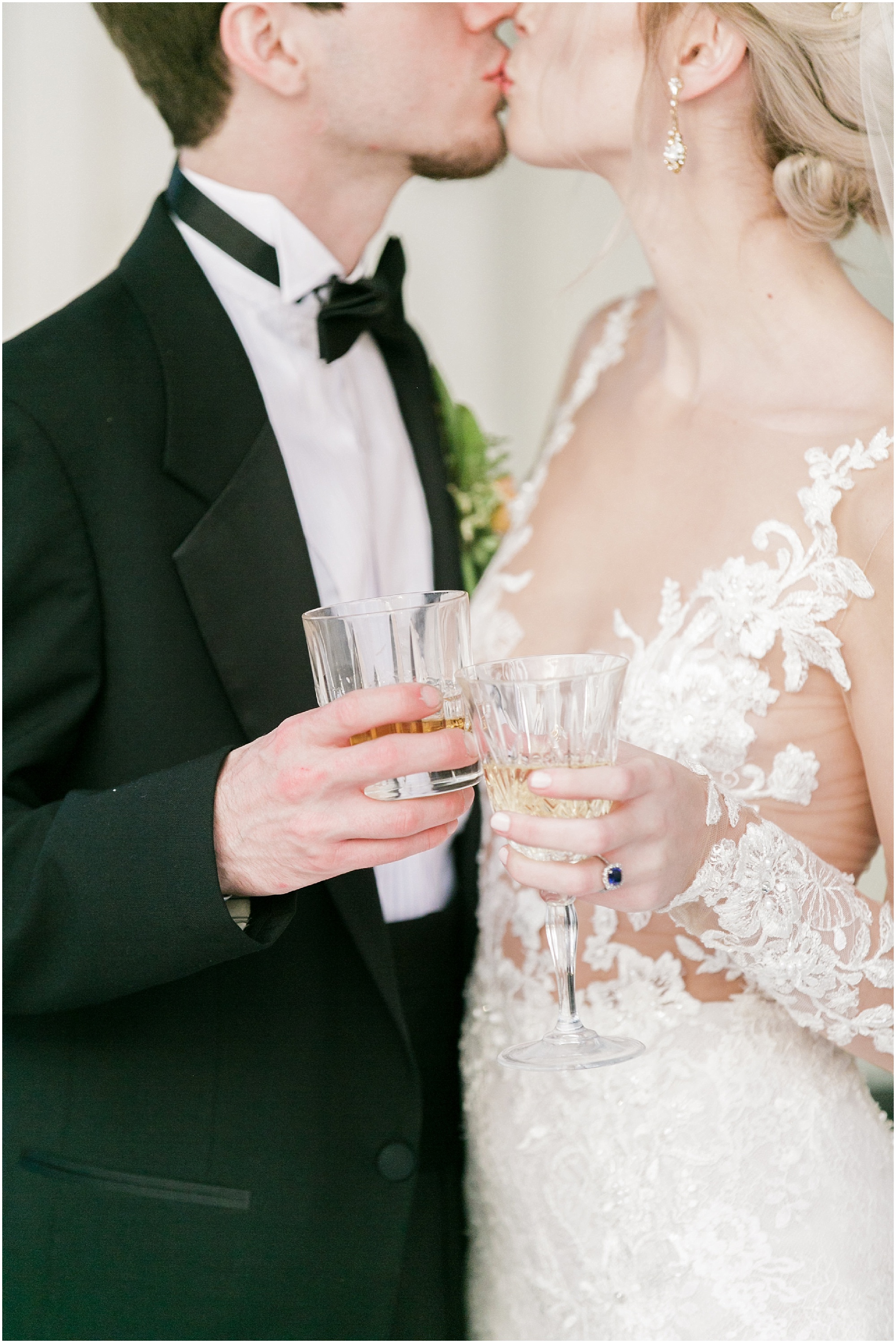 Timeless Southern Wedding bride and groom kiss while toasting.