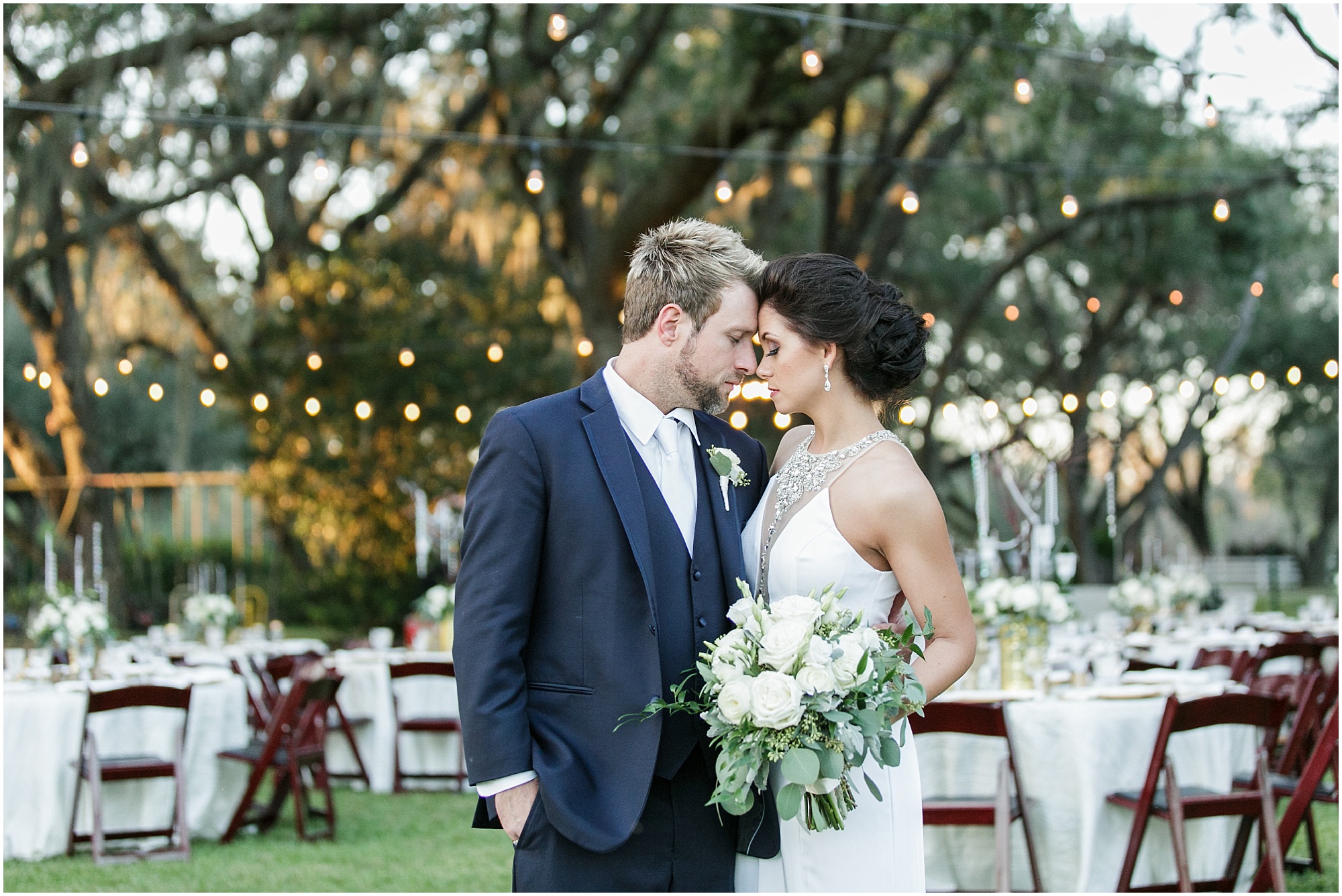Bride and groom with their head together at their outdoor reception site at Rocking H Ranch.