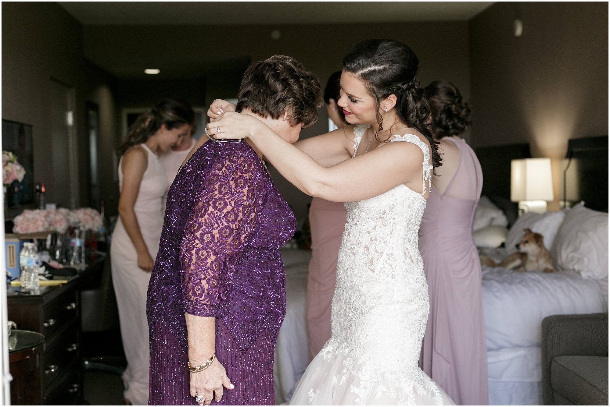 Bride putting a necklace on her mom. 