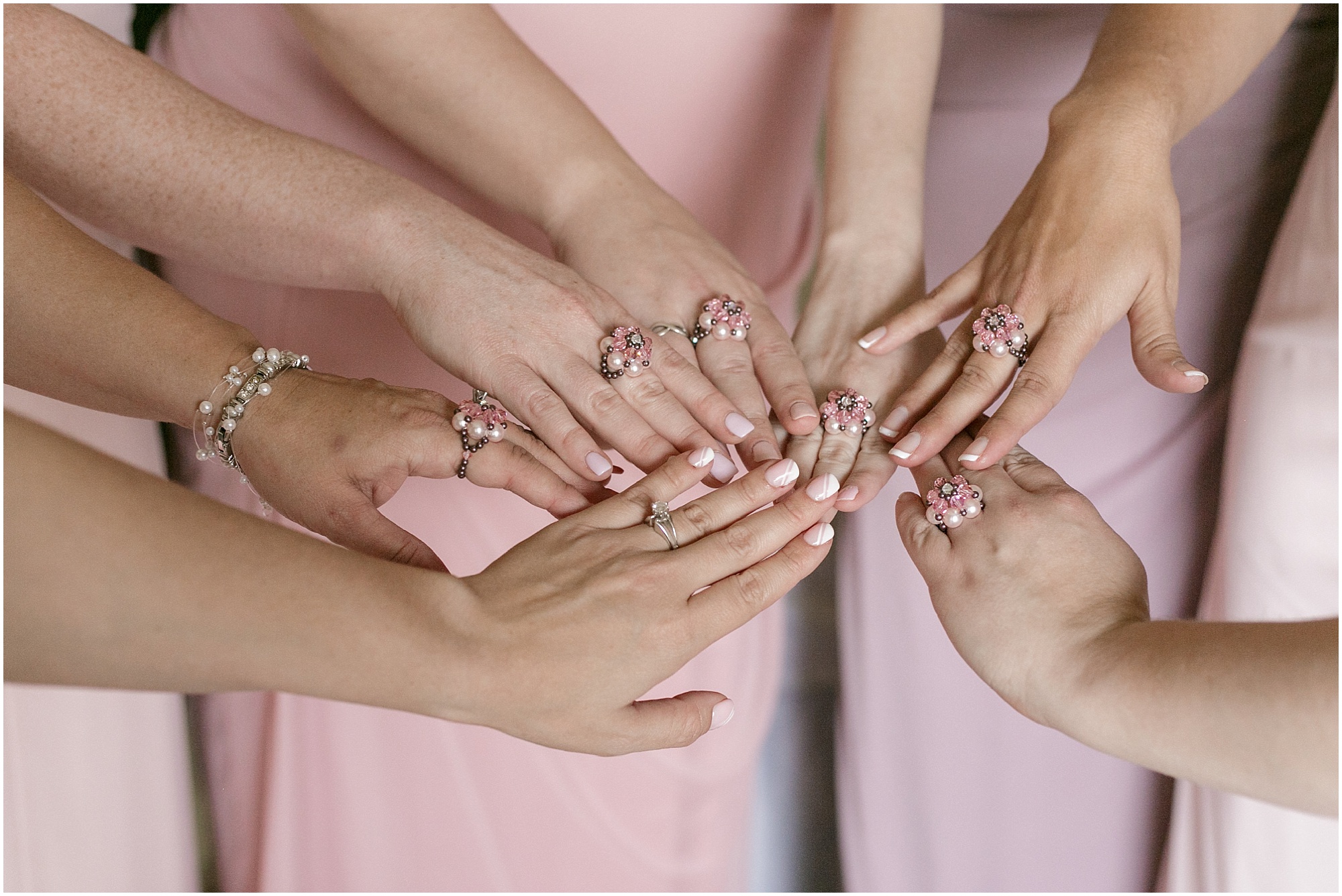 Bridesmaids showing off their matching pink rings. 
