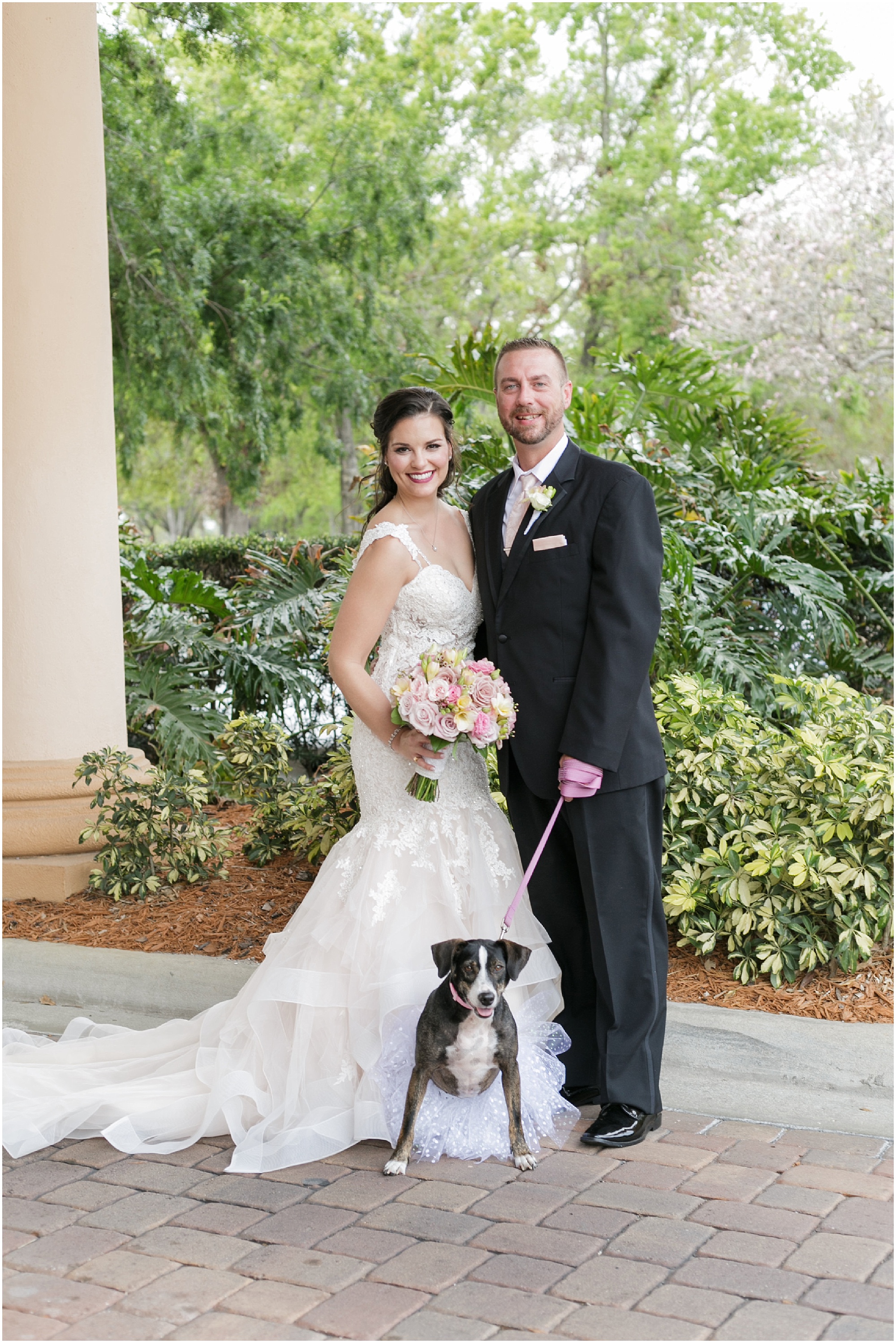Portrait of the bride, groom, and their dog. 