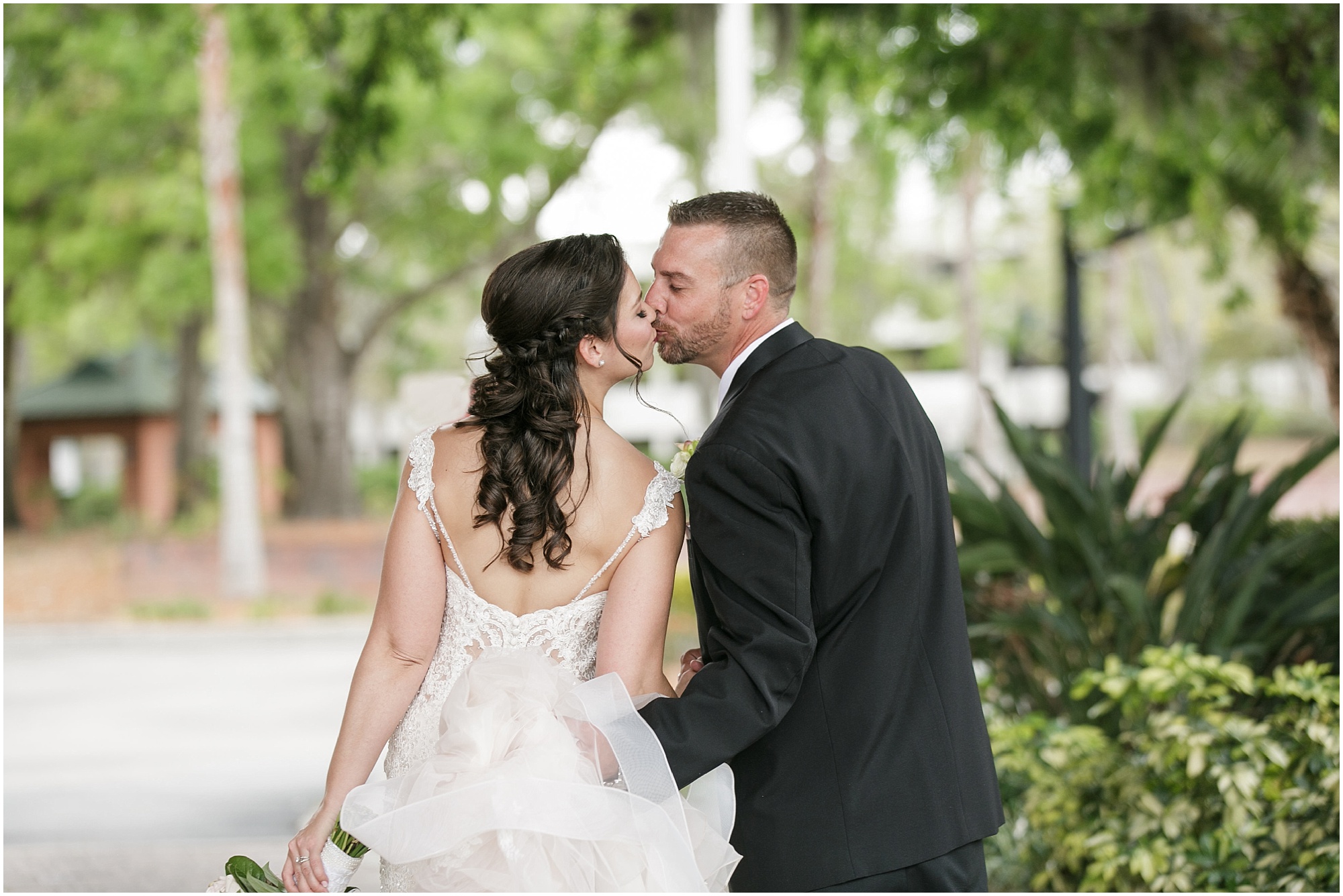 Bride and groom kissing as they walk away. 