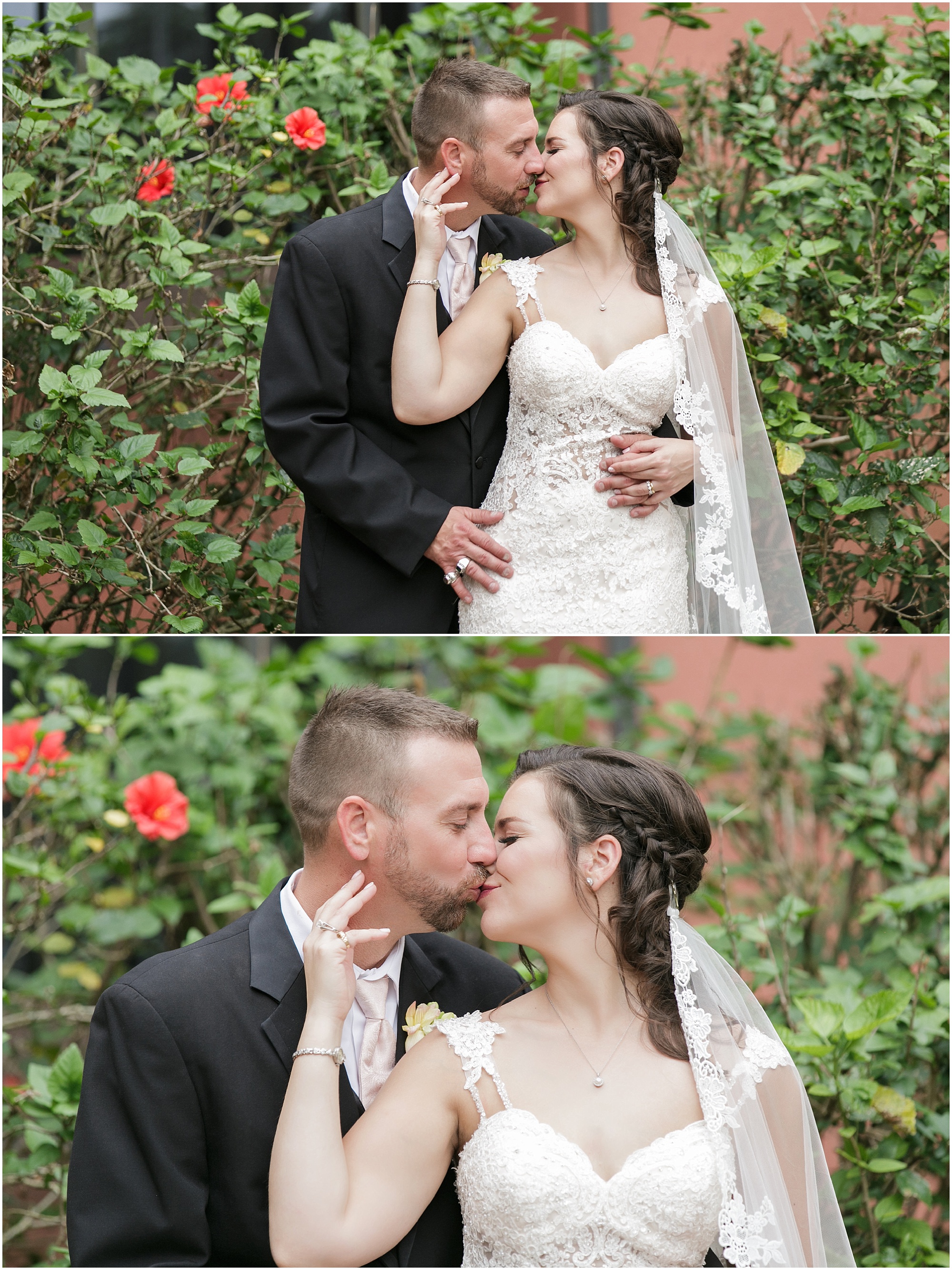 Bride and groom sharing a kiss in front of tall green plants. 
