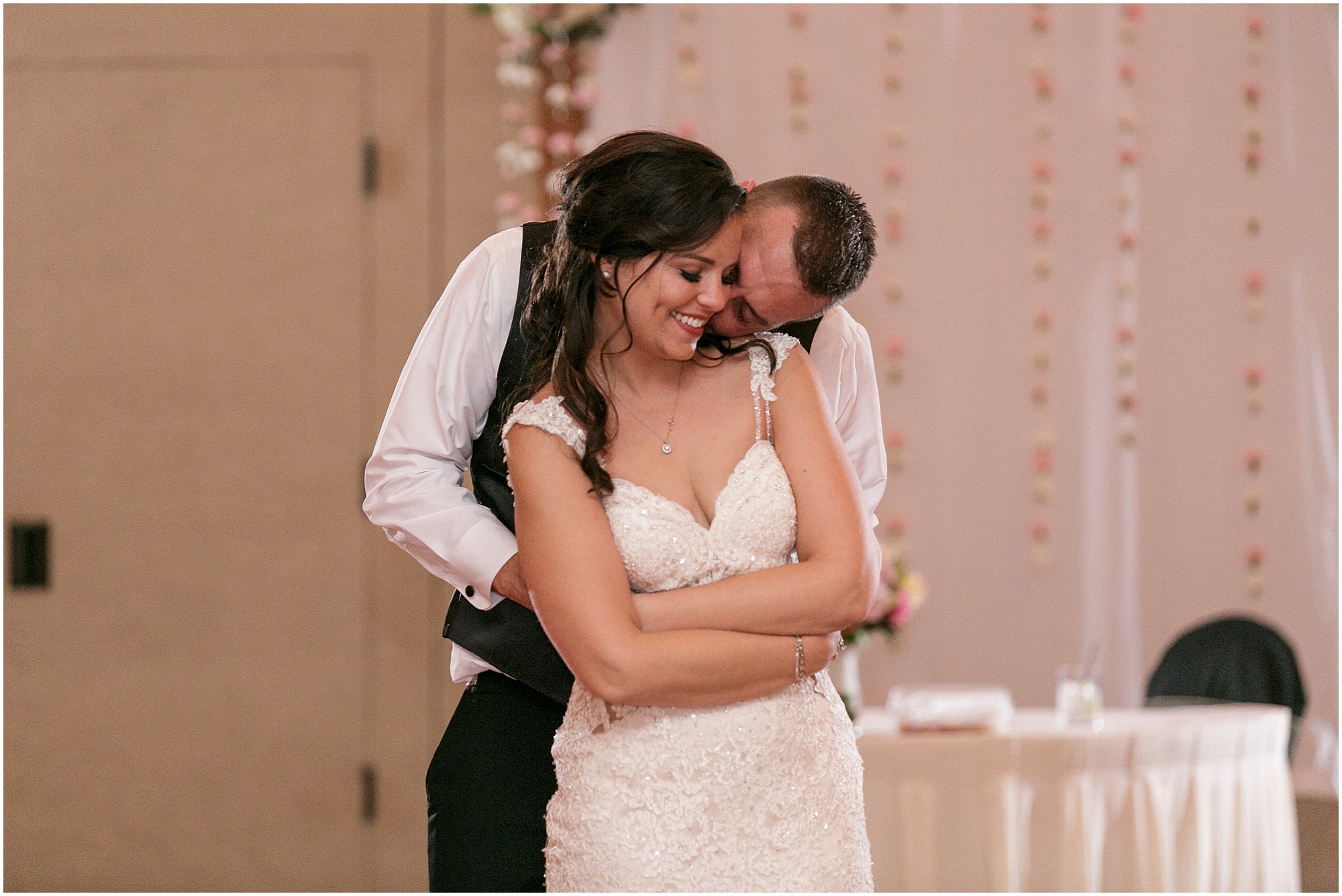 Bride and groom sharing their last dance at their classic pink and blush wedding reception. 