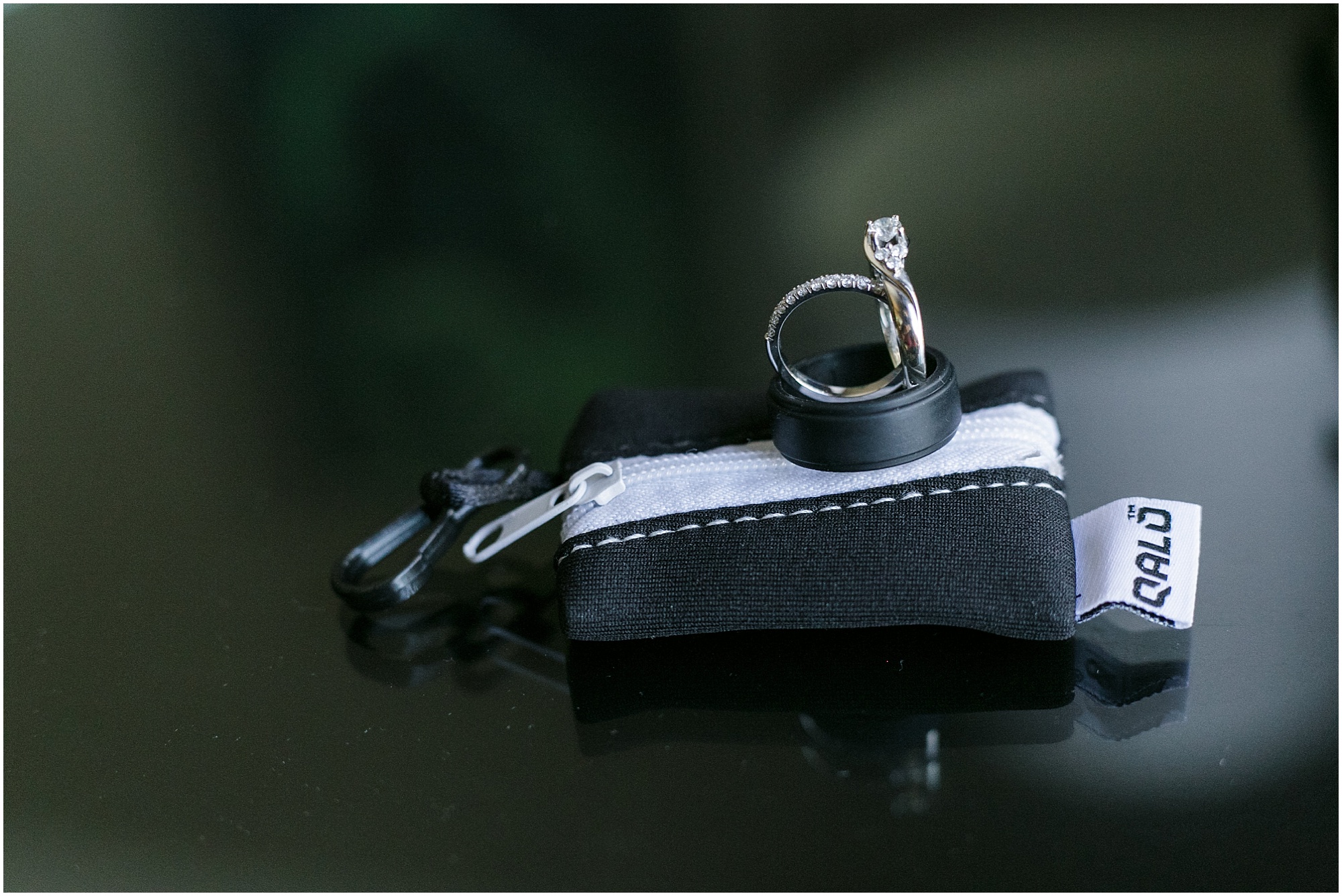 Wedding rings on a tuxedo ring purse.