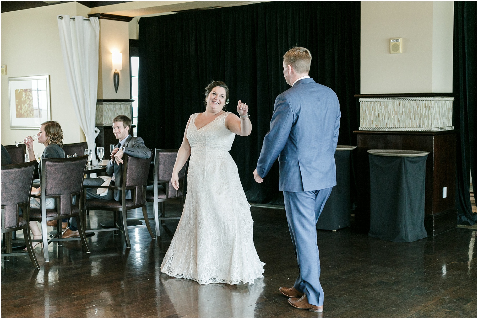 Bride jokes around with groom during their first dance. 