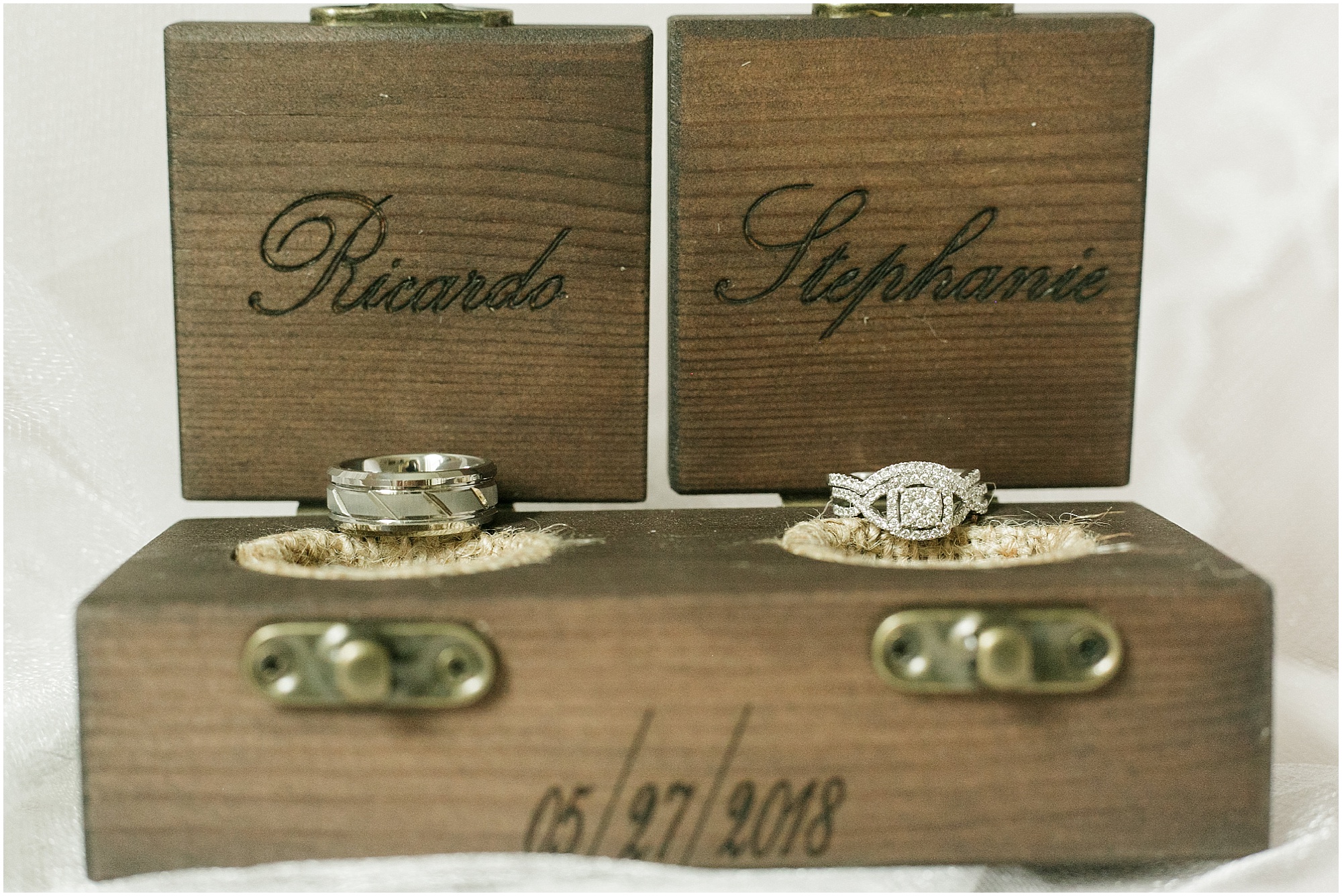 Bride and grooms wedding rings in a custom wooden ring box. 