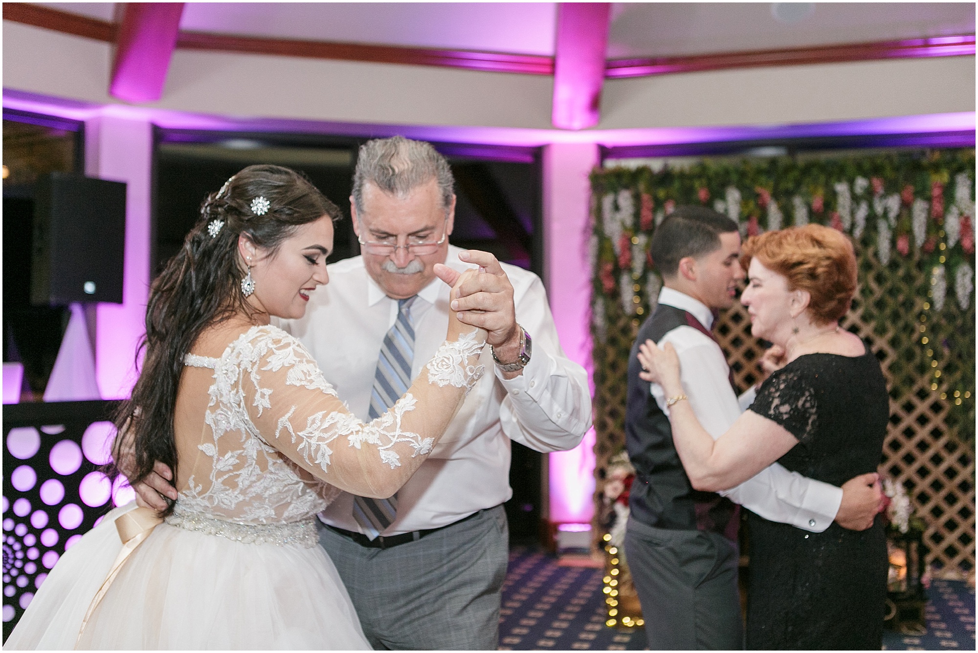 Bride and groom dance with family members at their reception. 