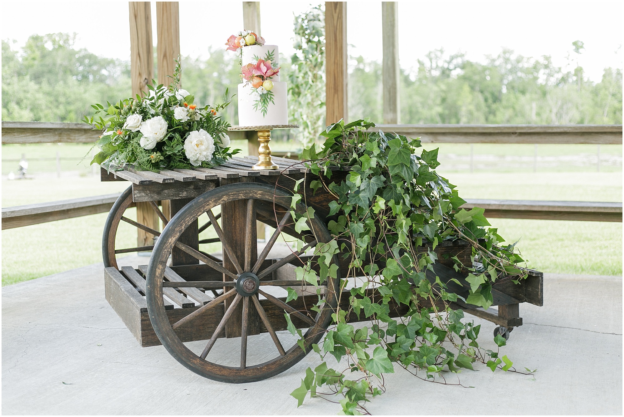 Florida inspired wedding cake sitting on an wooden wagon decorated with greenery. 